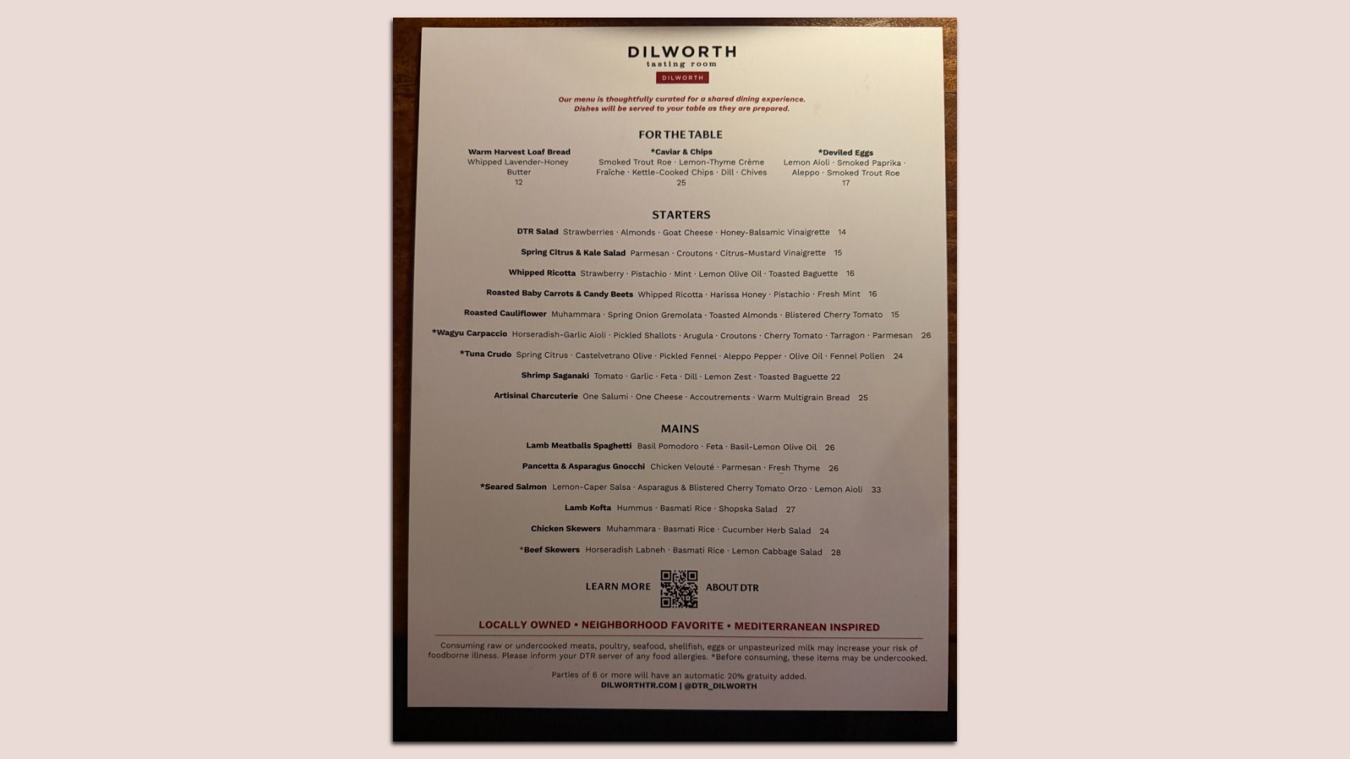 Menu from Dilworth Tasting Room listing shared dining dishes including breads, salads, crudos, mains like seared salmon and skewers; highlights Mediterranean-inspired, locally owned eatery.