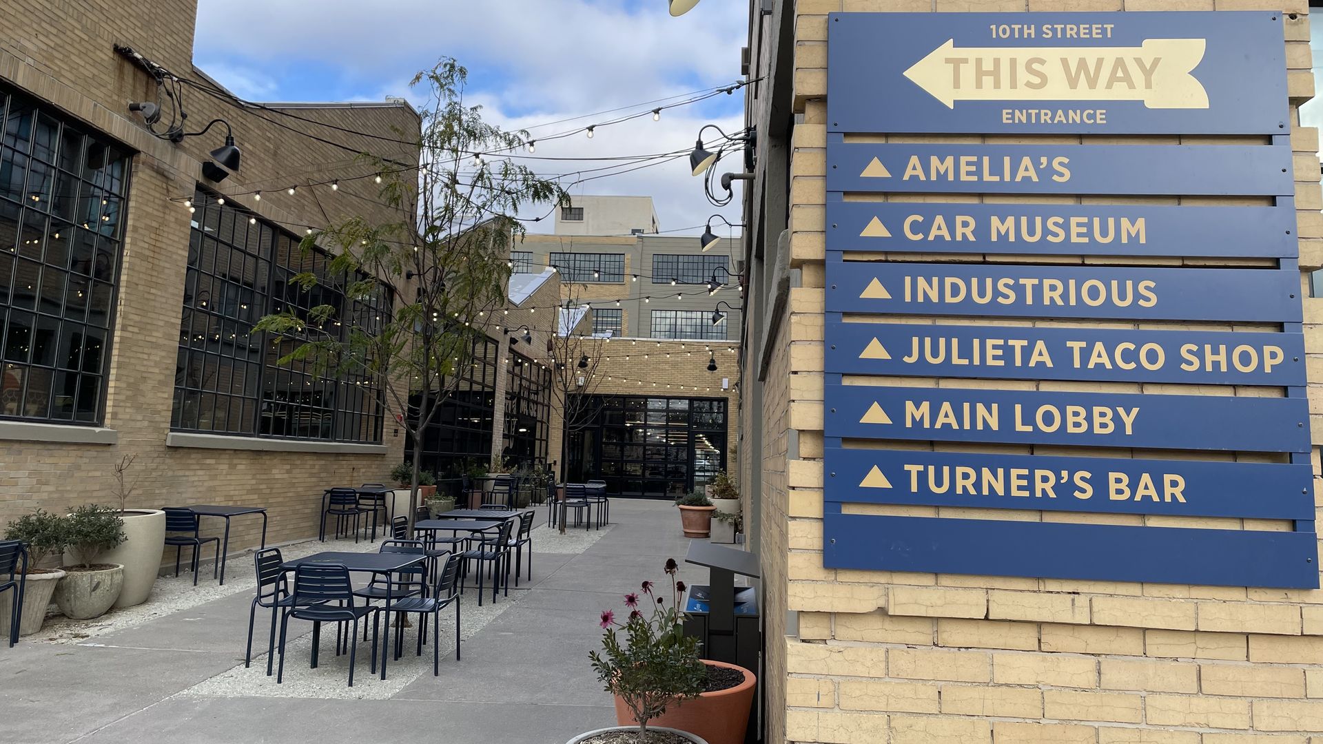 A blue sign points the way to businesses inside the Stutz building in downtown Indianapolis.
