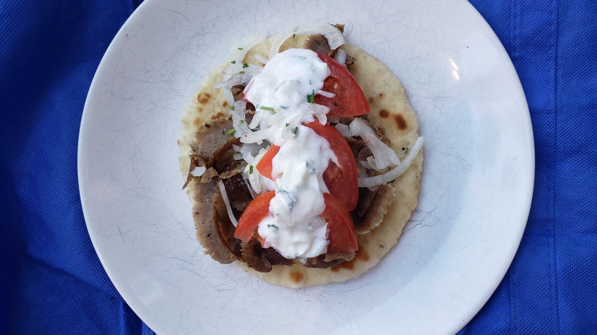 Photo of a gyros sandwich on a plate. 