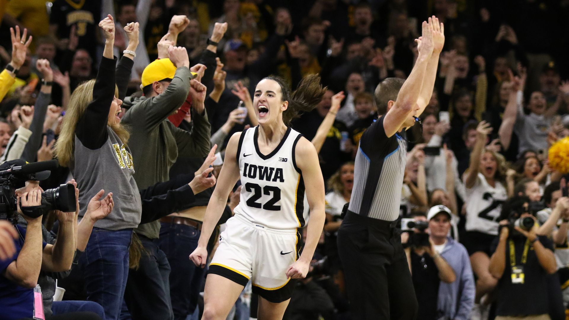 Caitlin Clark of Iowa celebrates after making a basket. 