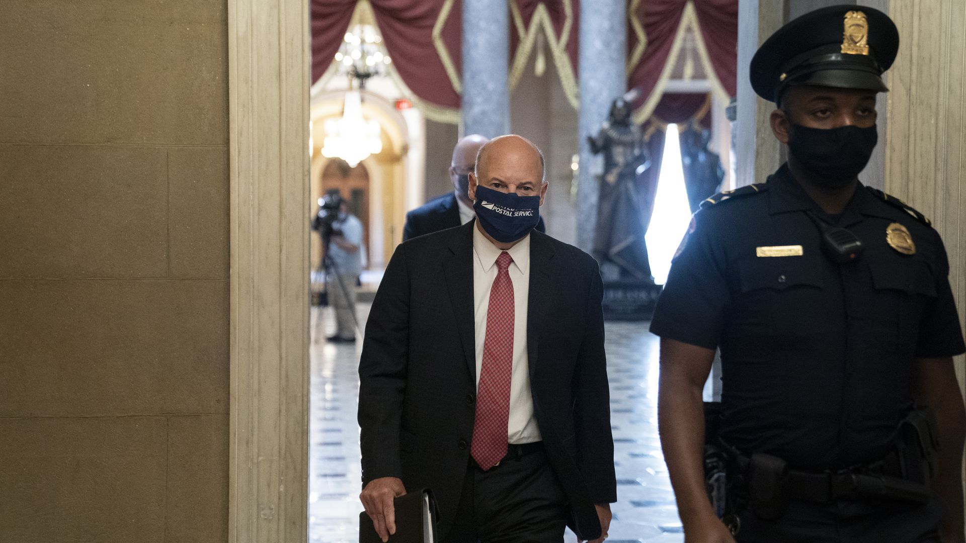 Postmaster General Louis DeJoy walking through the Capitol on August 5.
