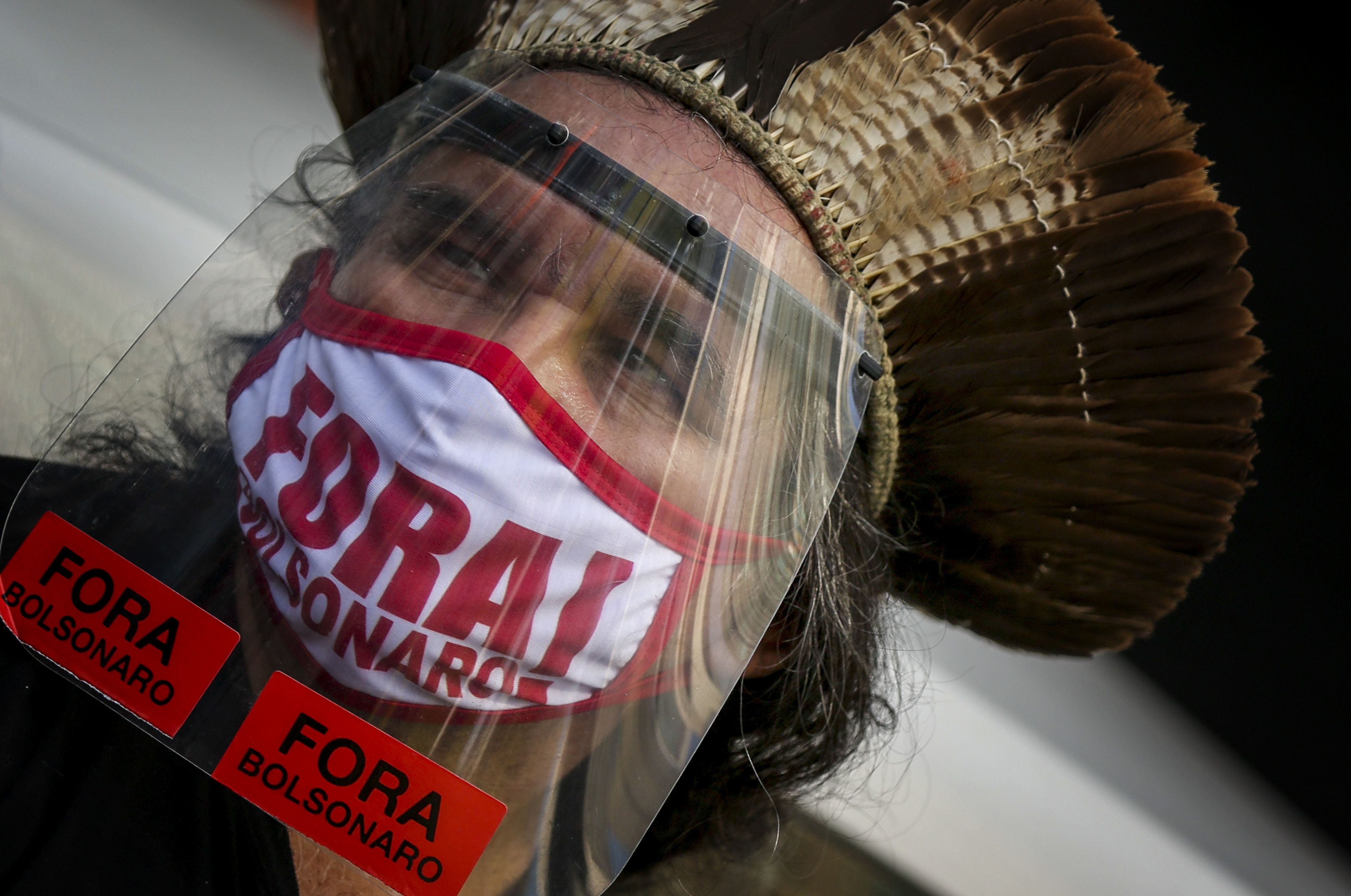  A demonstrator wears a protective face mask with the phrase in Portuguese: "Bolsonaro out" during a protest against his governement on May 29, 2021 in Rio de Janeiro, Brazil. 
