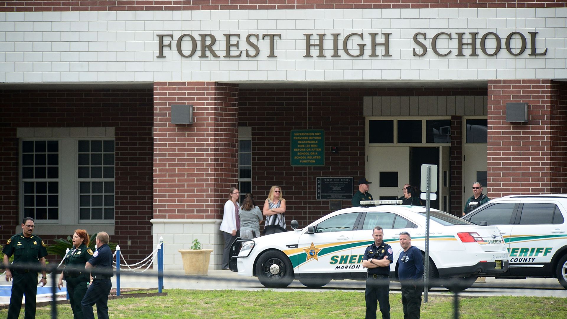 Police officers in front of Forest High School