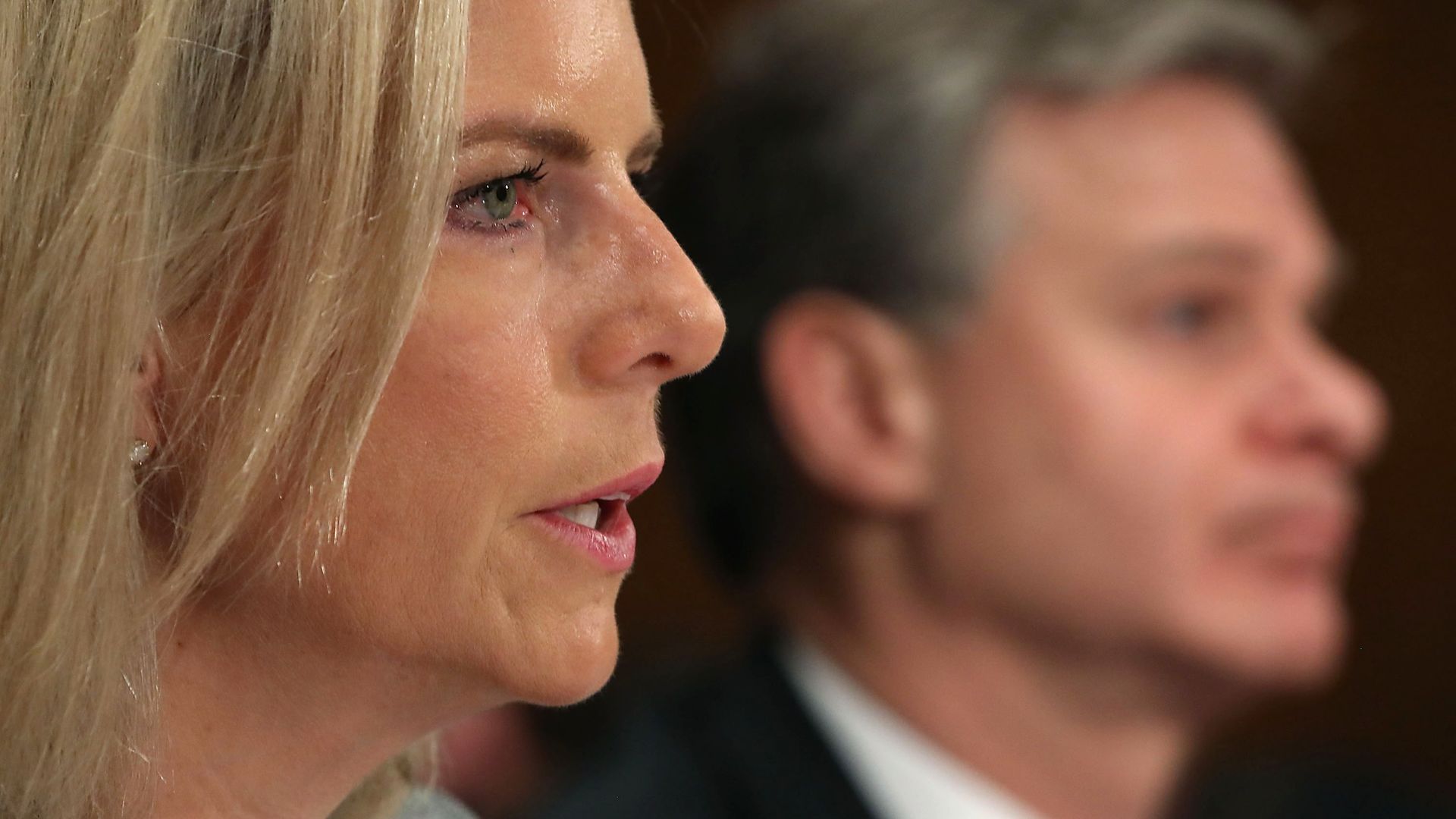 A close up of the profile of DHS Secretary Kirstjen Nielsen testifying for Congress. 