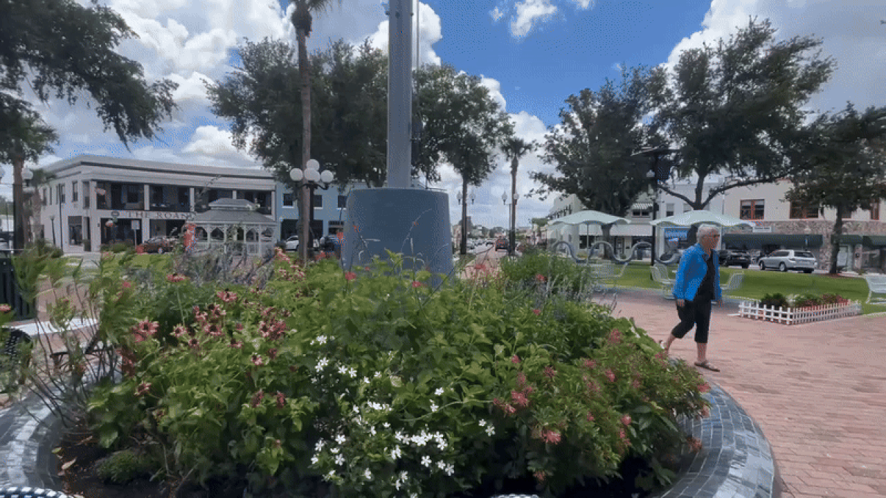 A video of a historic downtown surrounding a circular park.