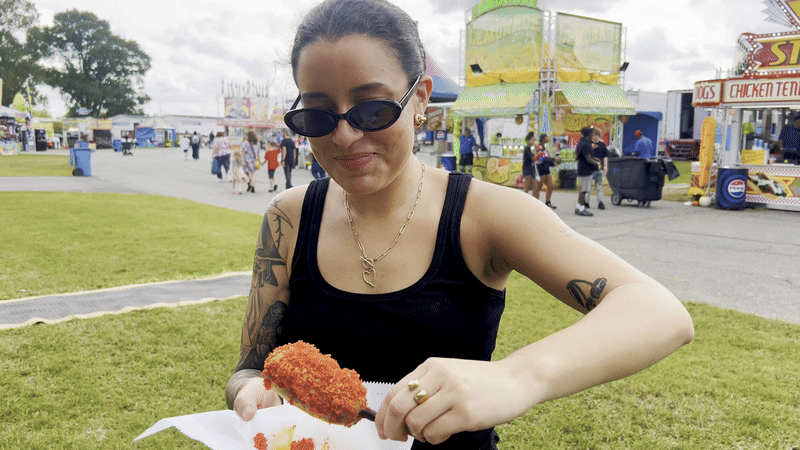 Sabrina eating a corn dog  