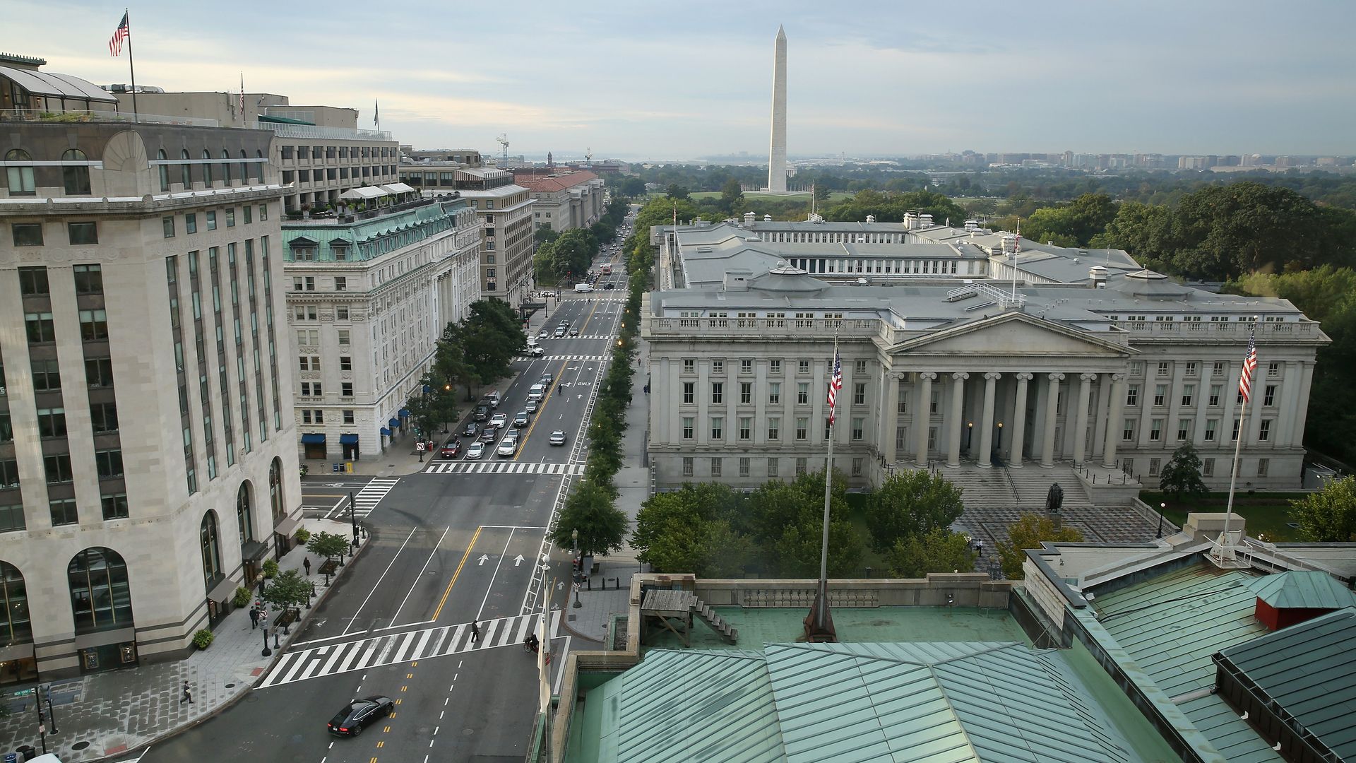 This image is a birds-eye view of the Treasury Building and the street next to it in DC. The Washington monument is seen in the distance.