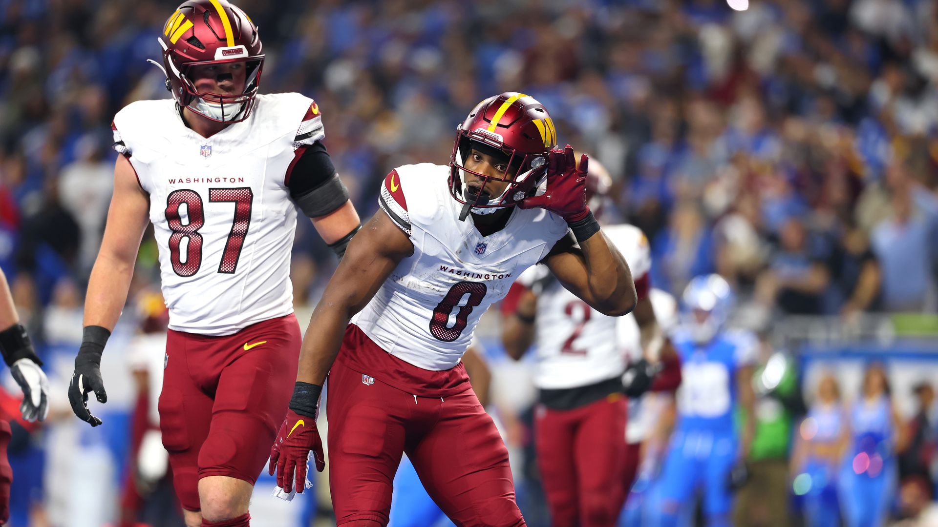 DETROIT, MICHIGAN - JANUARY 18: Brian Robinson Jr. #8 of the Washington Commanders reacts after running the ball for a touchdown during the second quarter against the Detroit Lions in the NFC Divisional Playoff at Ford Field on January 18, 2025 in Detroit, Michigan. (Photo by Gregory Shamus/Getty Im