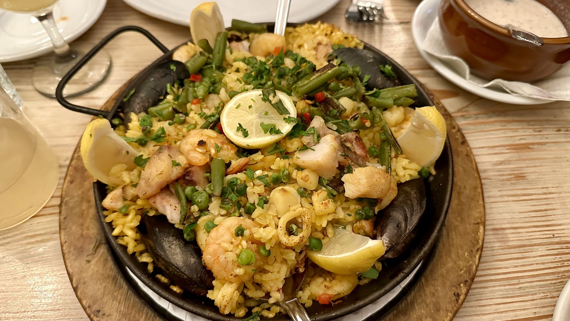 Photo shows paella in a cooking pan on a table