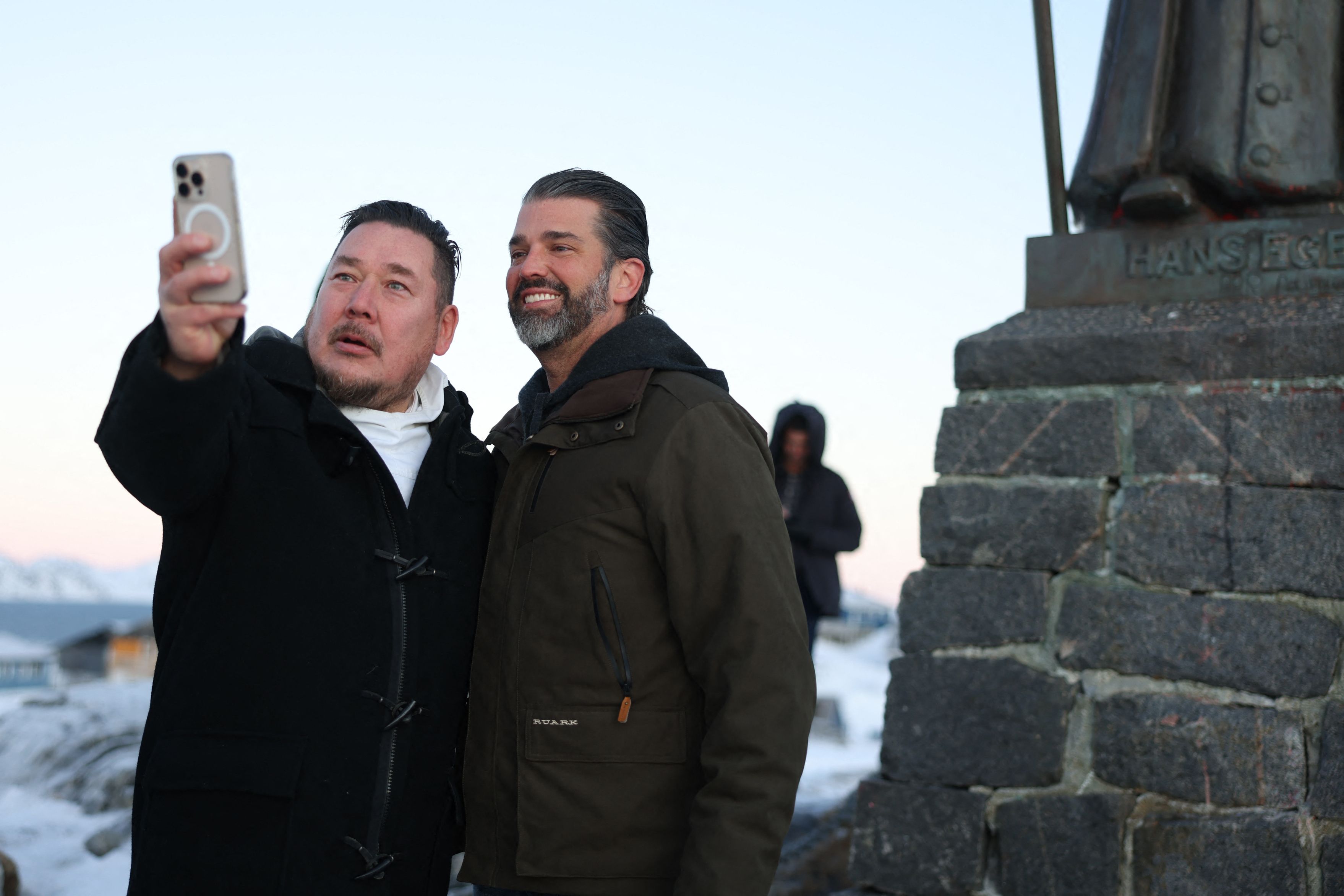 A wellwisher takes a picture with US businessman Donald Trump Jr. after arriving in Nuuk, Greenland on January 7, 2025. Donald Trump Jr made a private visit to Greenland, a Danish autonomous territory coveted by Trump Sr and which hopes to one day be independent but remains dependent on Copenhagen f
