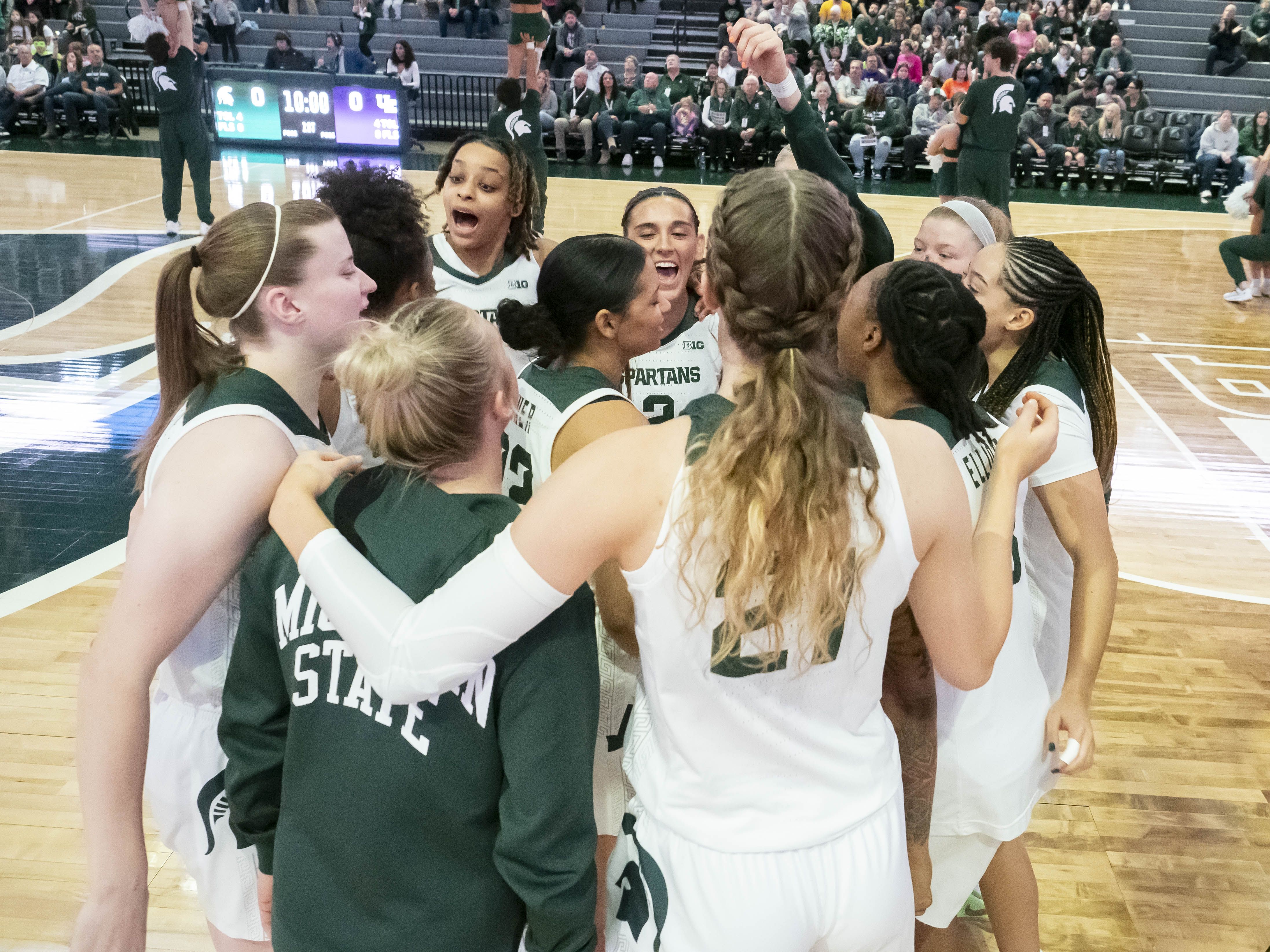 Photo of women celebrating on a basketball court