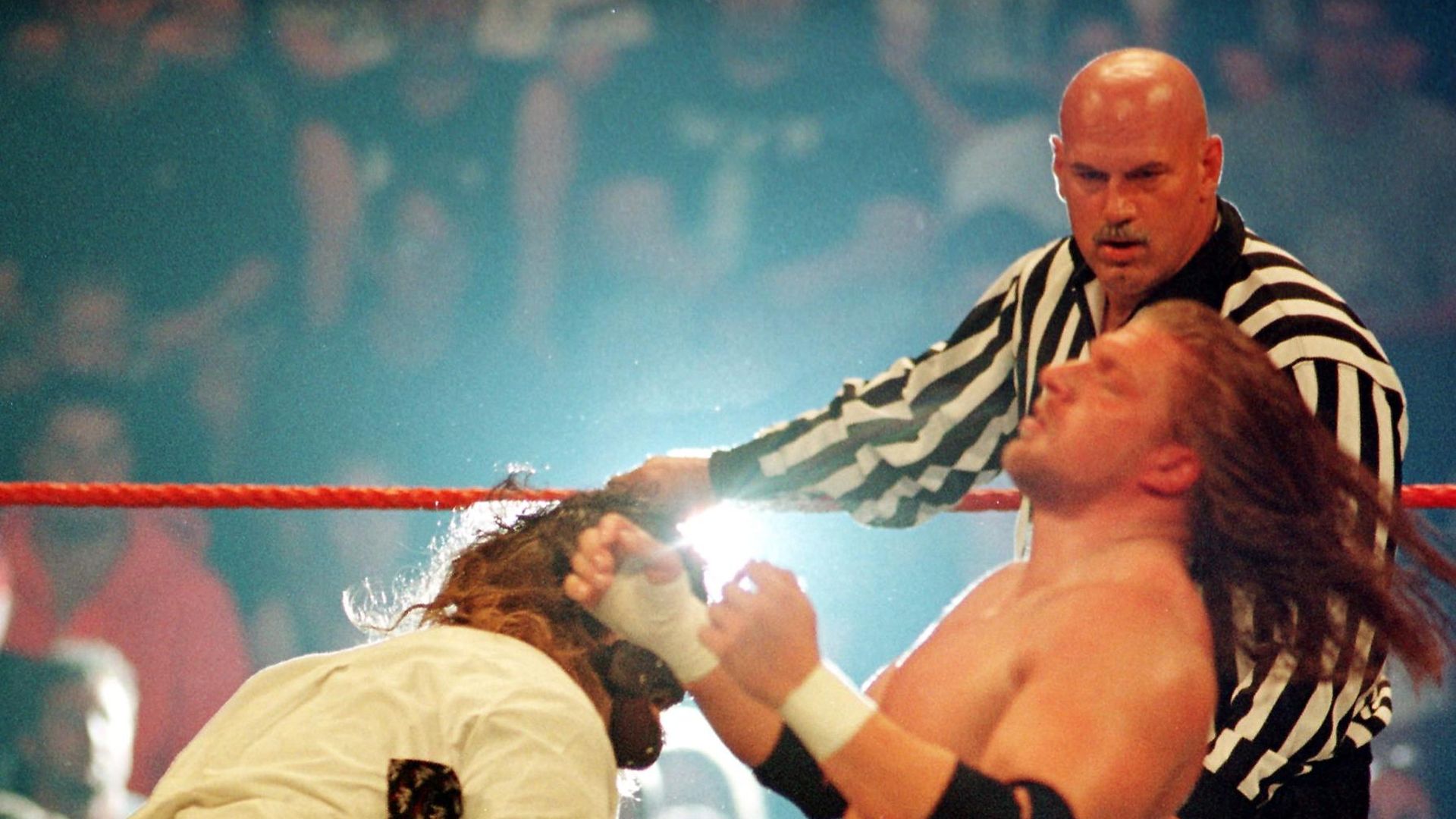 Jesse Ventura referees as Mankind and Triple H wrestle 