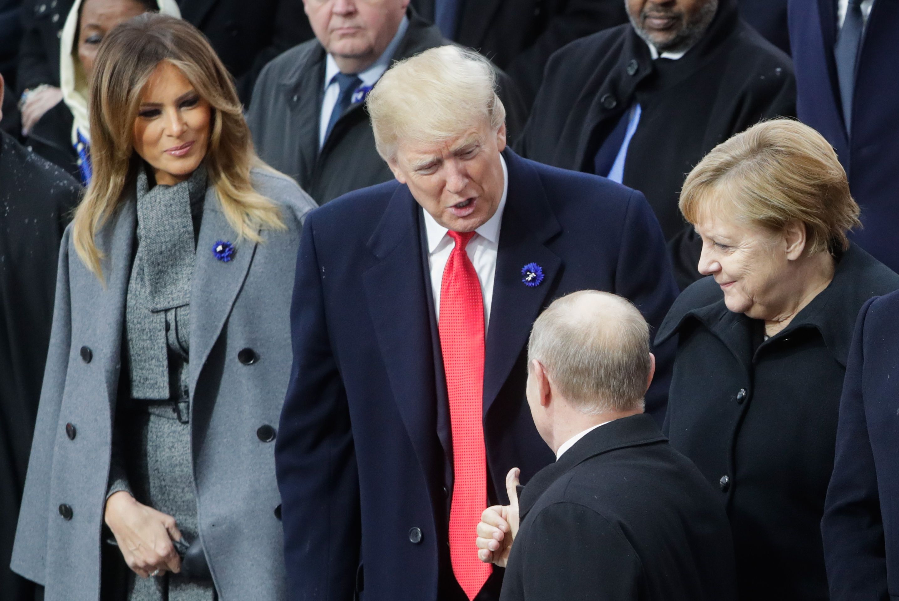 Melania and Trump greeting Vladimir Putin