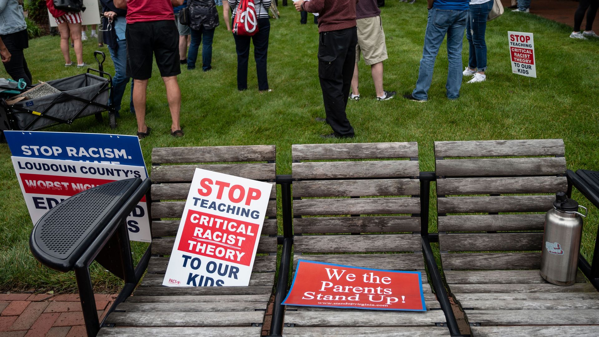 Signs on a bench decrying the teaching of critical race theory in schools