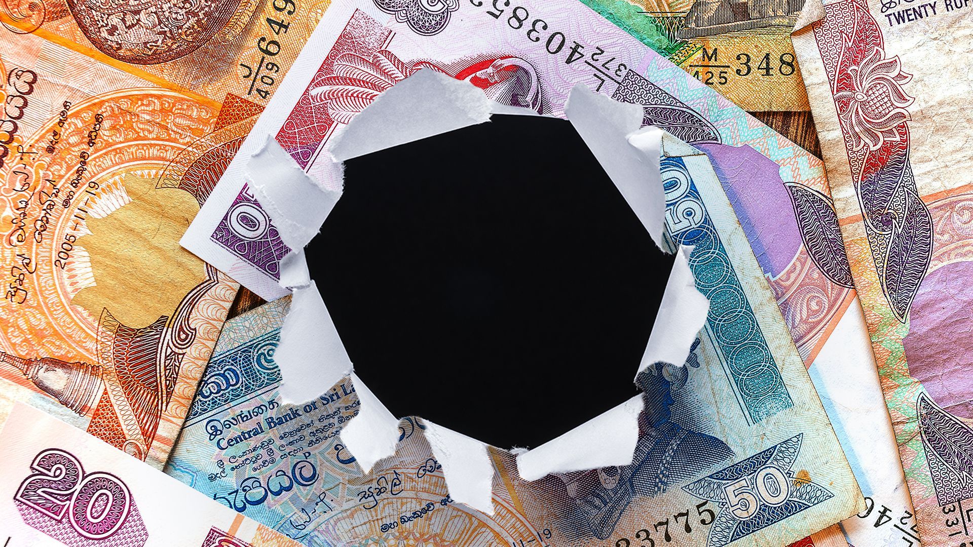 Illustration of a pile of Sri Lankan rupees with a hole torn in the center