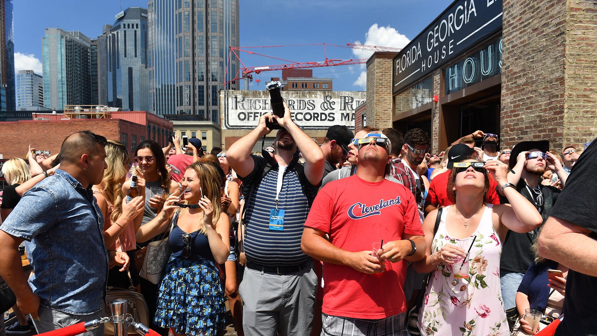 People looking at the sky with eclipse glasses on.