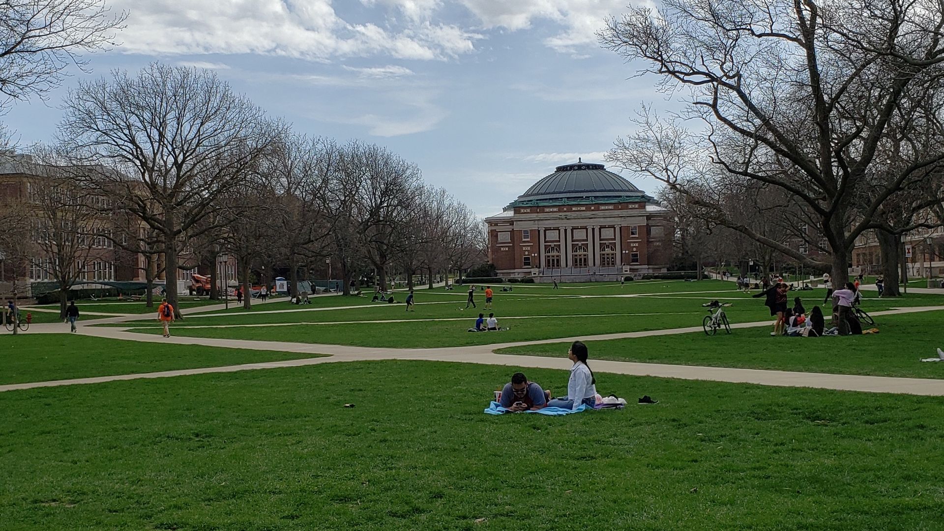 Photo of people laying down in the grass.
