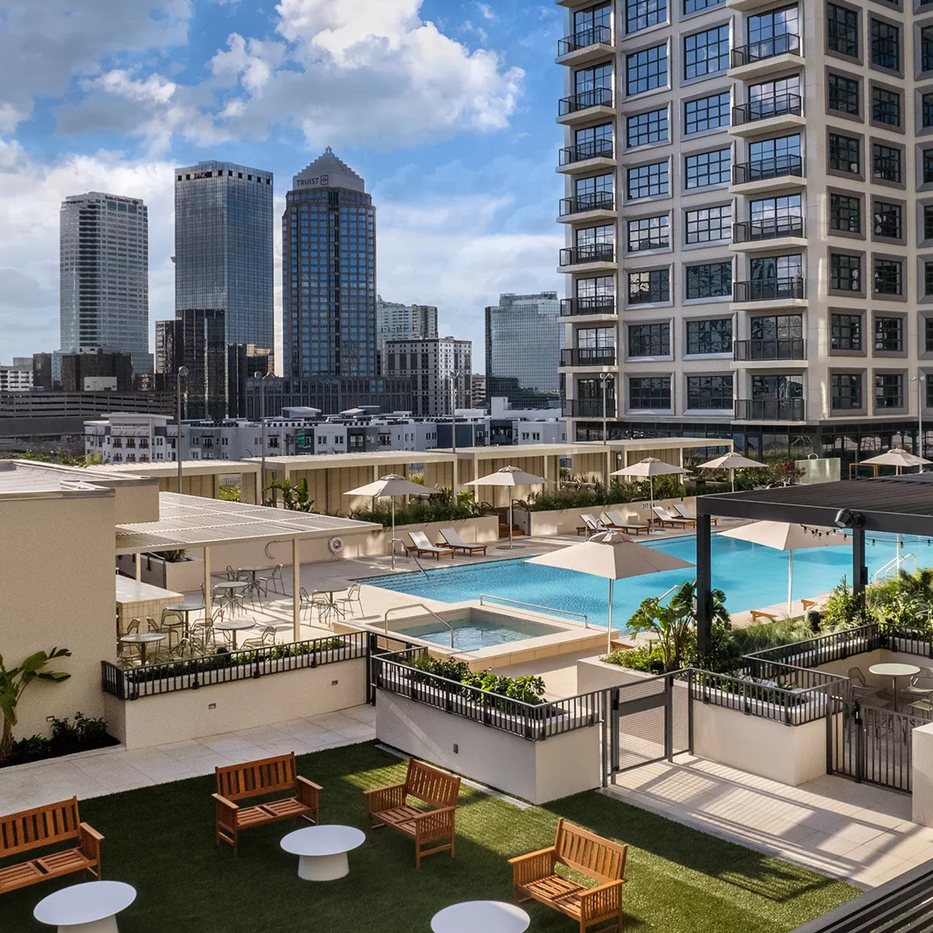 A rooftop pool with a turf lounge area on the roof of Asher