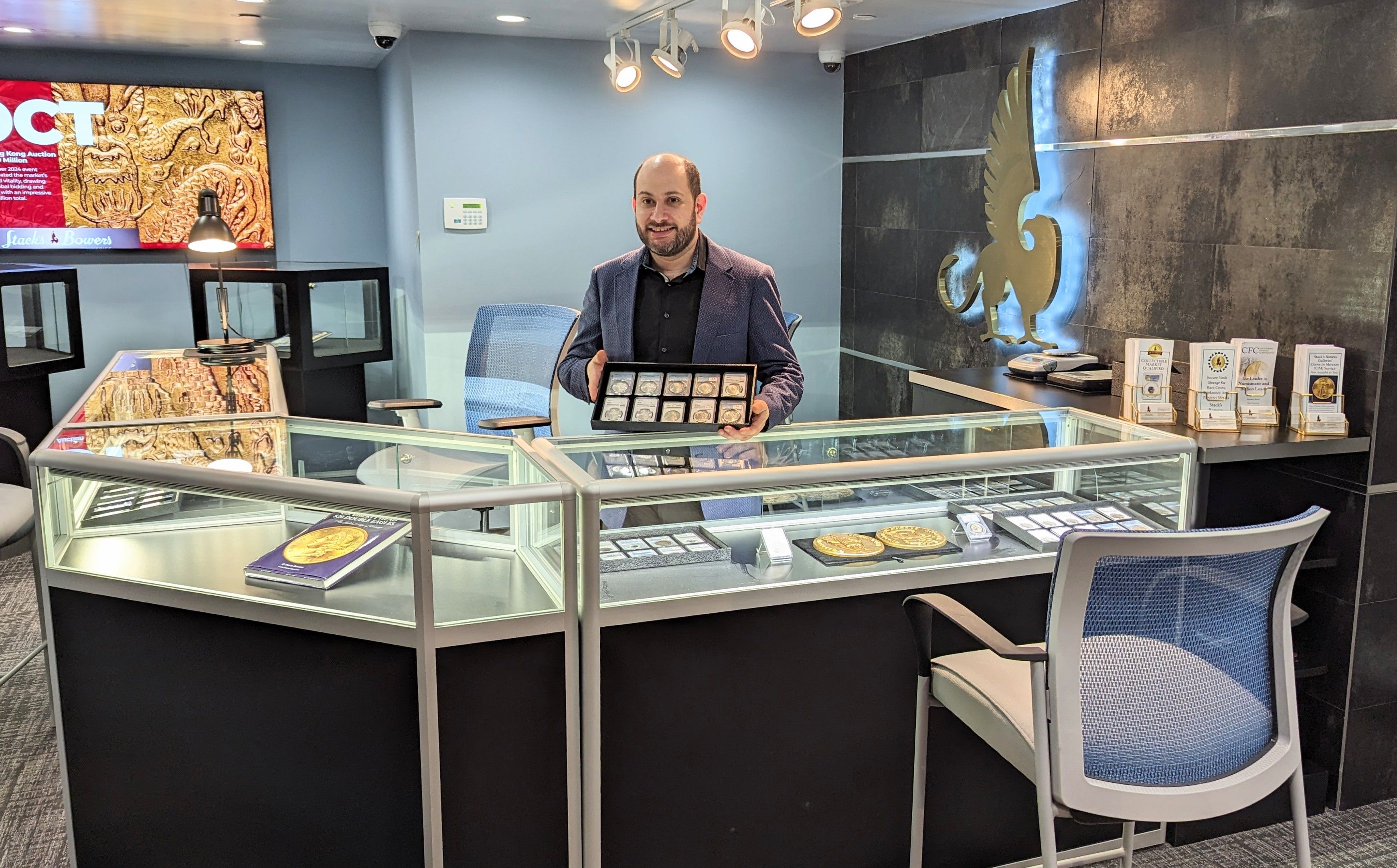 A man holding rare coins in the Stack's Bowers Galleries. 