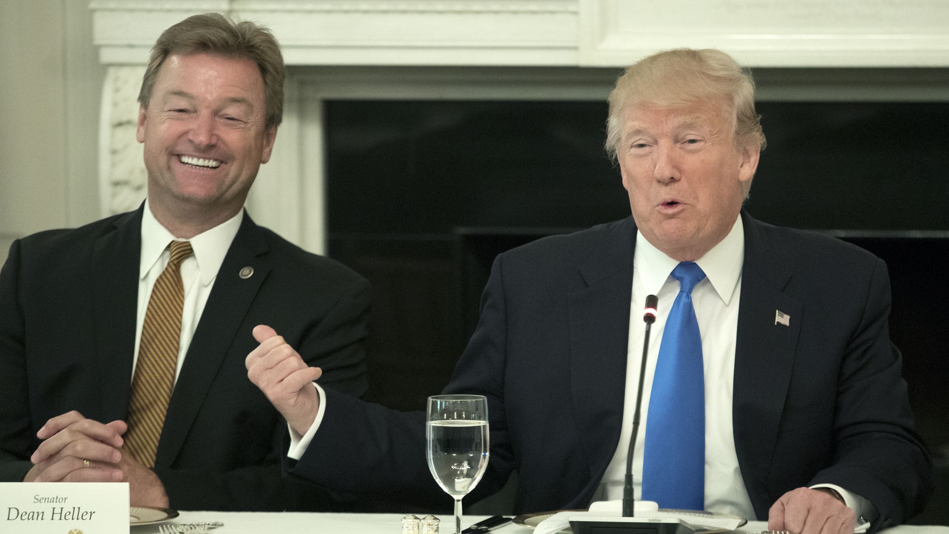 Sen. Dean Heller and President Trump sitting at a table next to each other