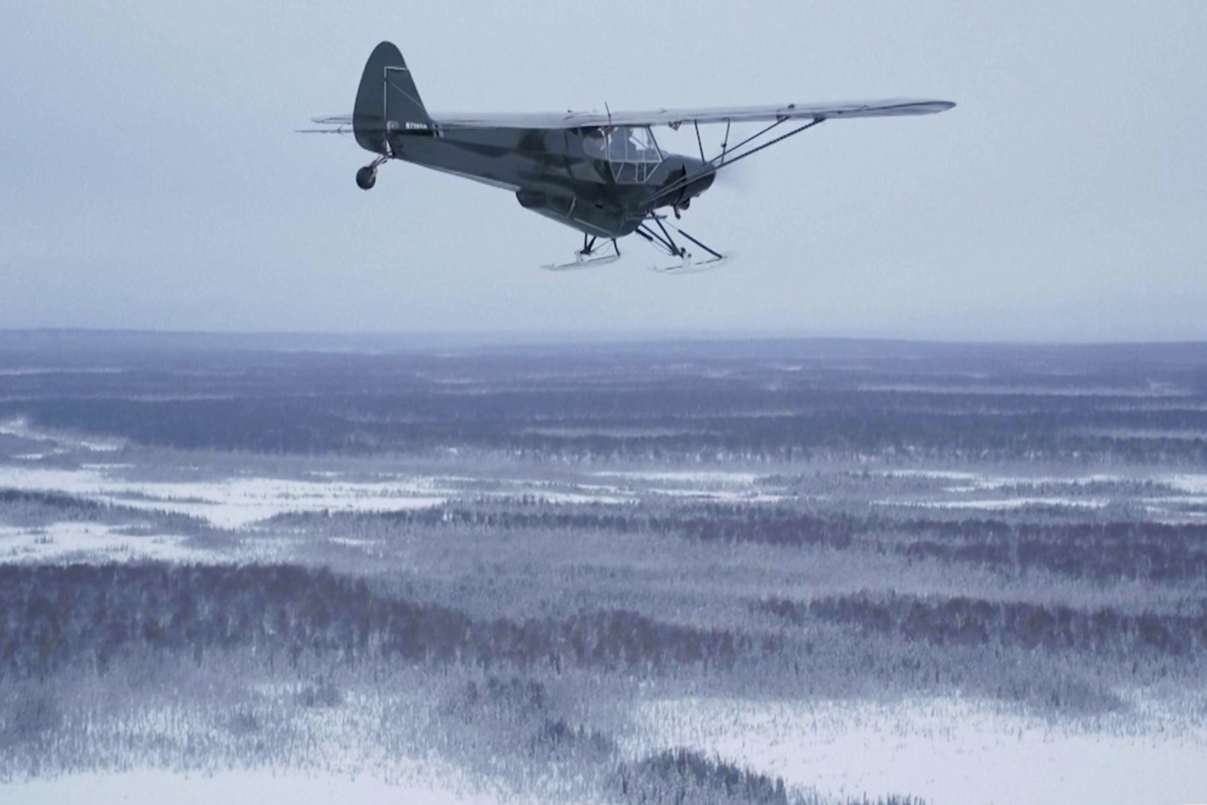 This image taken from video provided by Mountain Mind Media/Alaska Gear Company shows a plane from Alaska Turkey Bomb, which was started by Esther Keim to air drop frozen turkeys for Thanksgiving to people living in remote rural Alaska, flying in November 2024, in Alaska. (Mountain Mind Media/Alaska