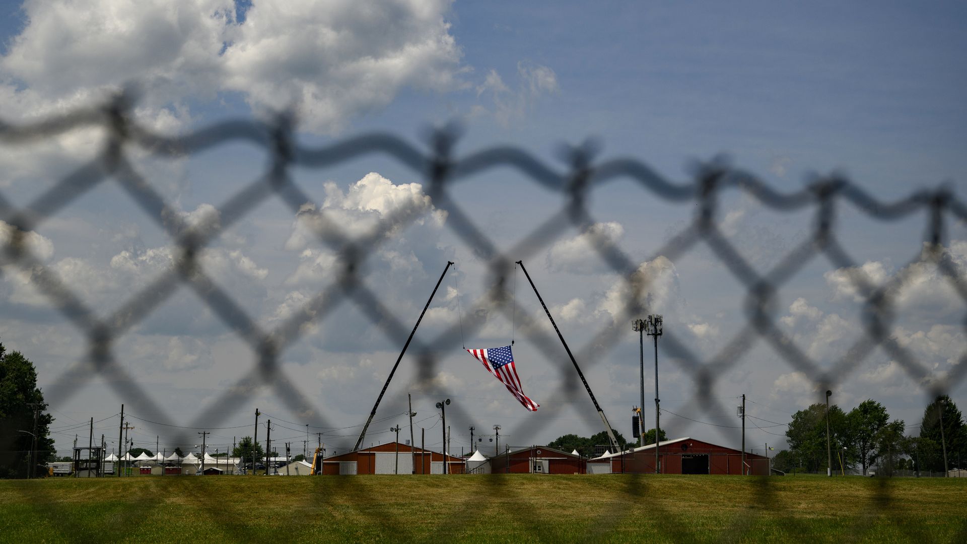 An American flag hangs over the site of the attempted Trump assassination.