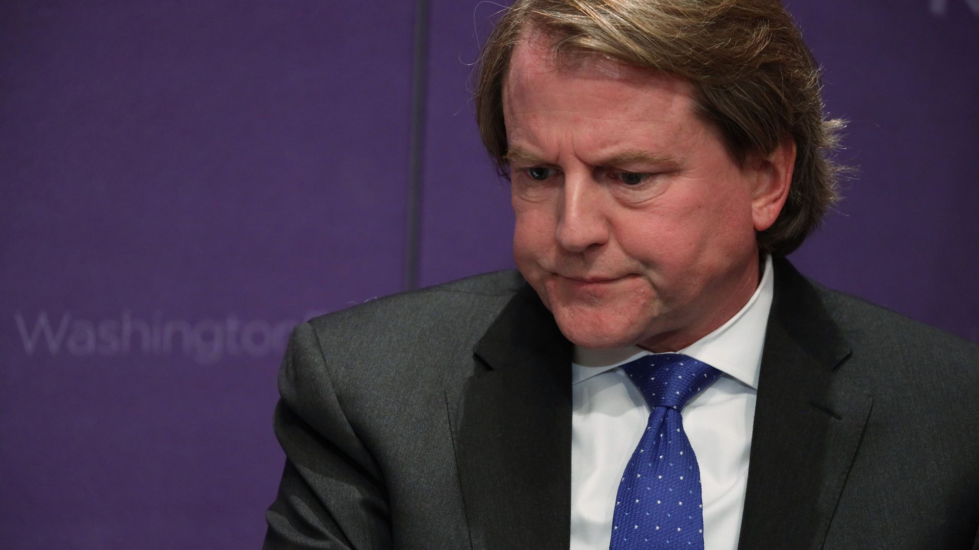 Don McGahn sits in a suit and tie 