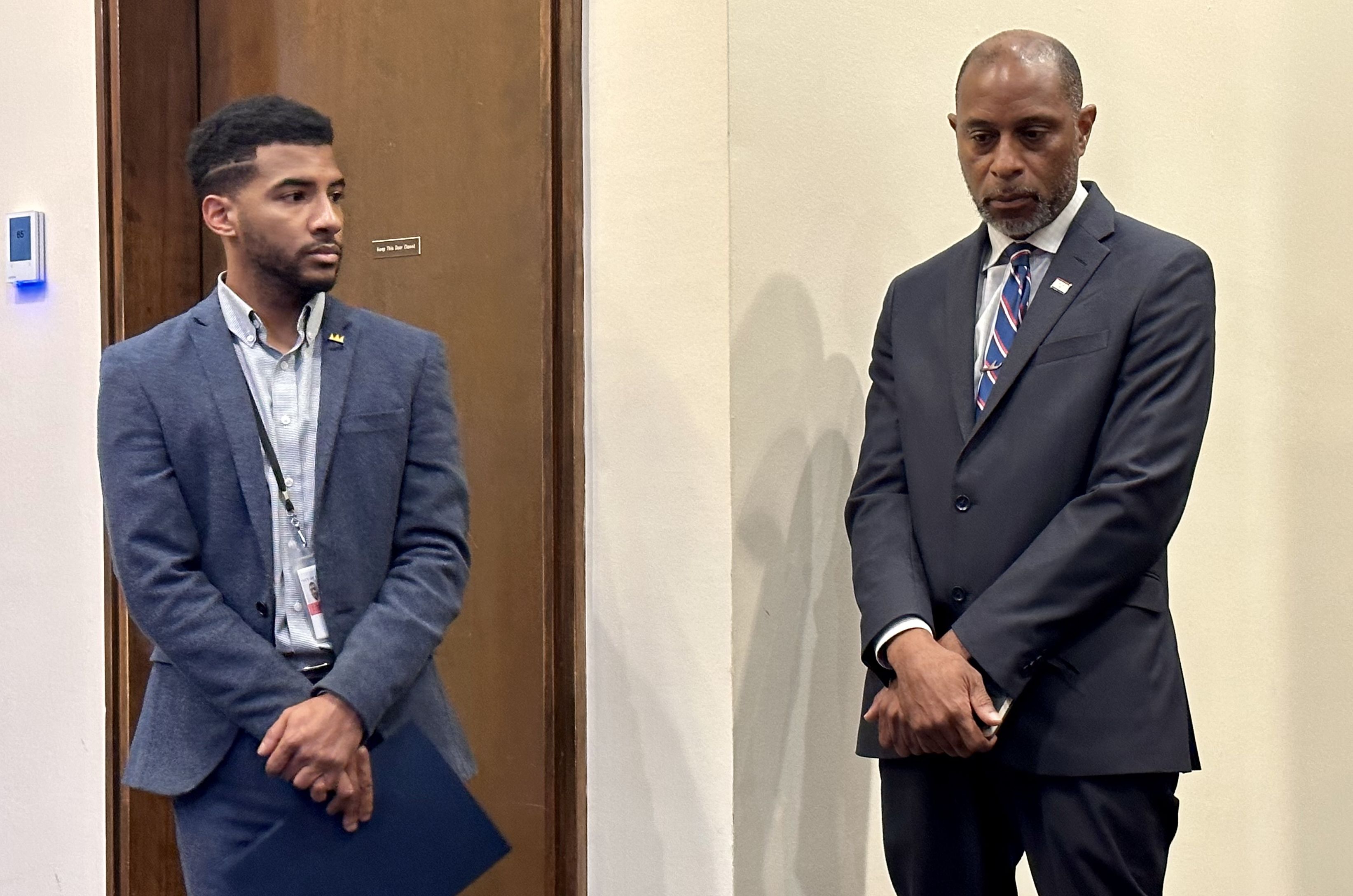 Photo shows Gregory Joseph and Andrew Logan, both members of the mayor's communications team, at a media briefing.
