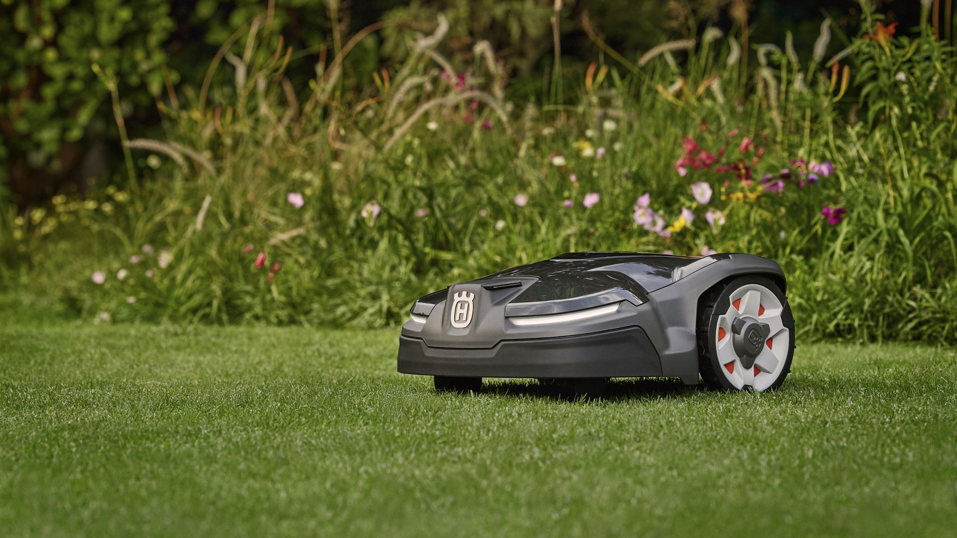 A robotic lawnmower in a field of grass.