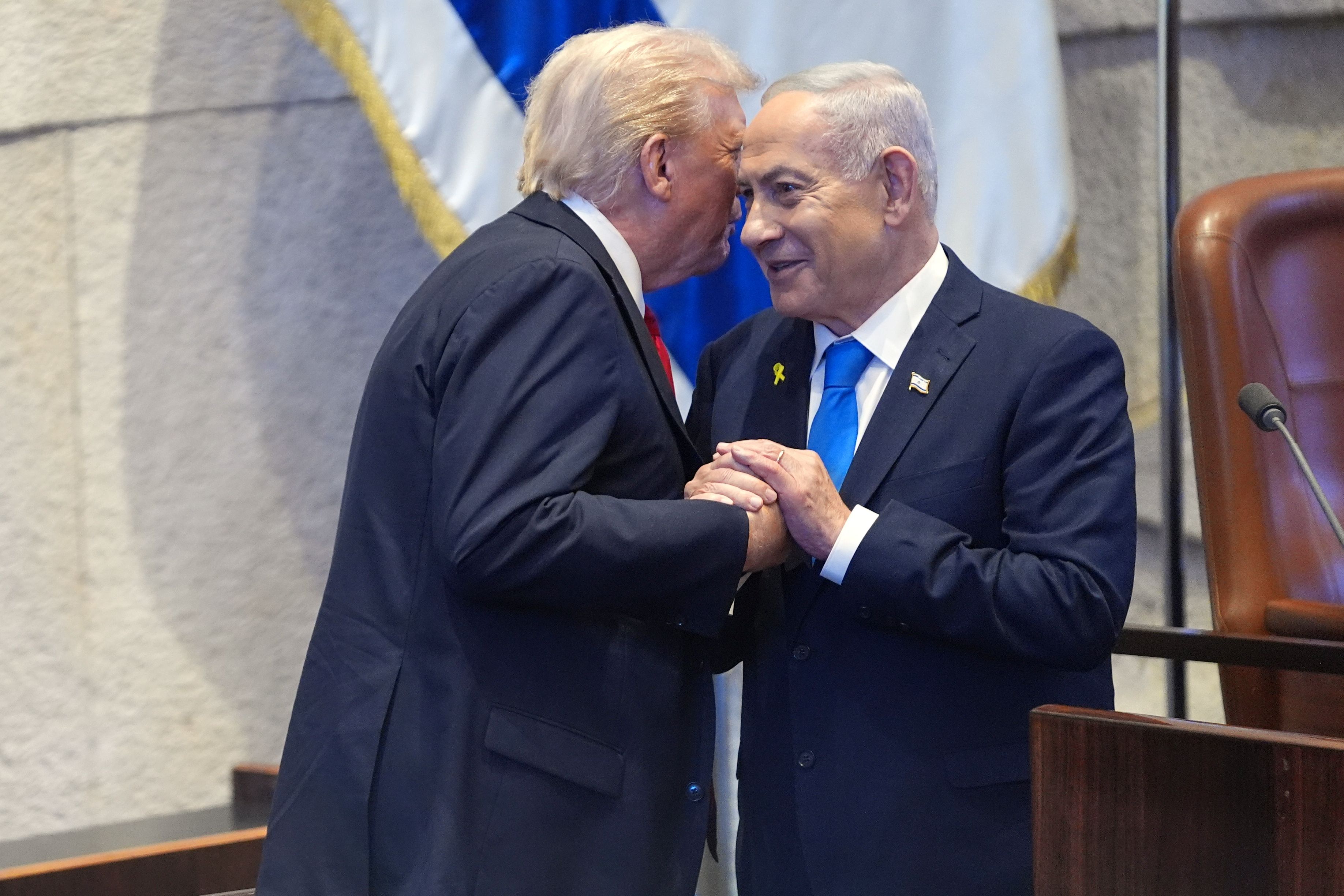 President Donald Trump talks with Israel's Prime Minister Benjamin Netanyahu at the Knesset, Israel's parliament, Monday, Oct. 13, 2025, in Jerusalem. (AP Photo/Evan Vucci, Pool)