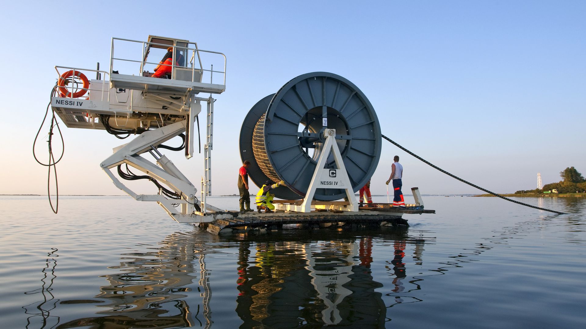 floating dock with workers installing underseas cable