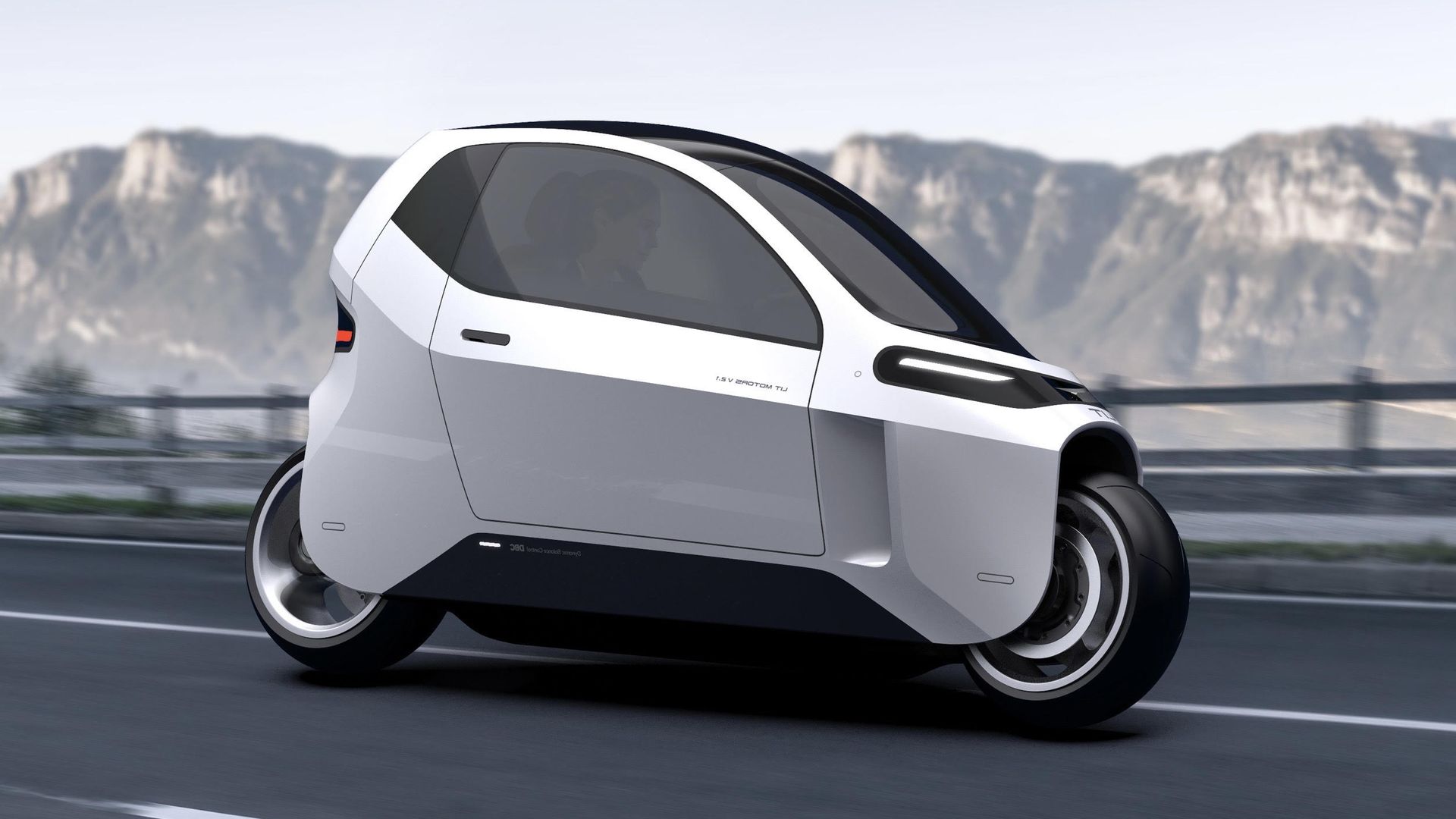 A rendering of a silver enclosed motorcycle speeding along a mountainside highway.