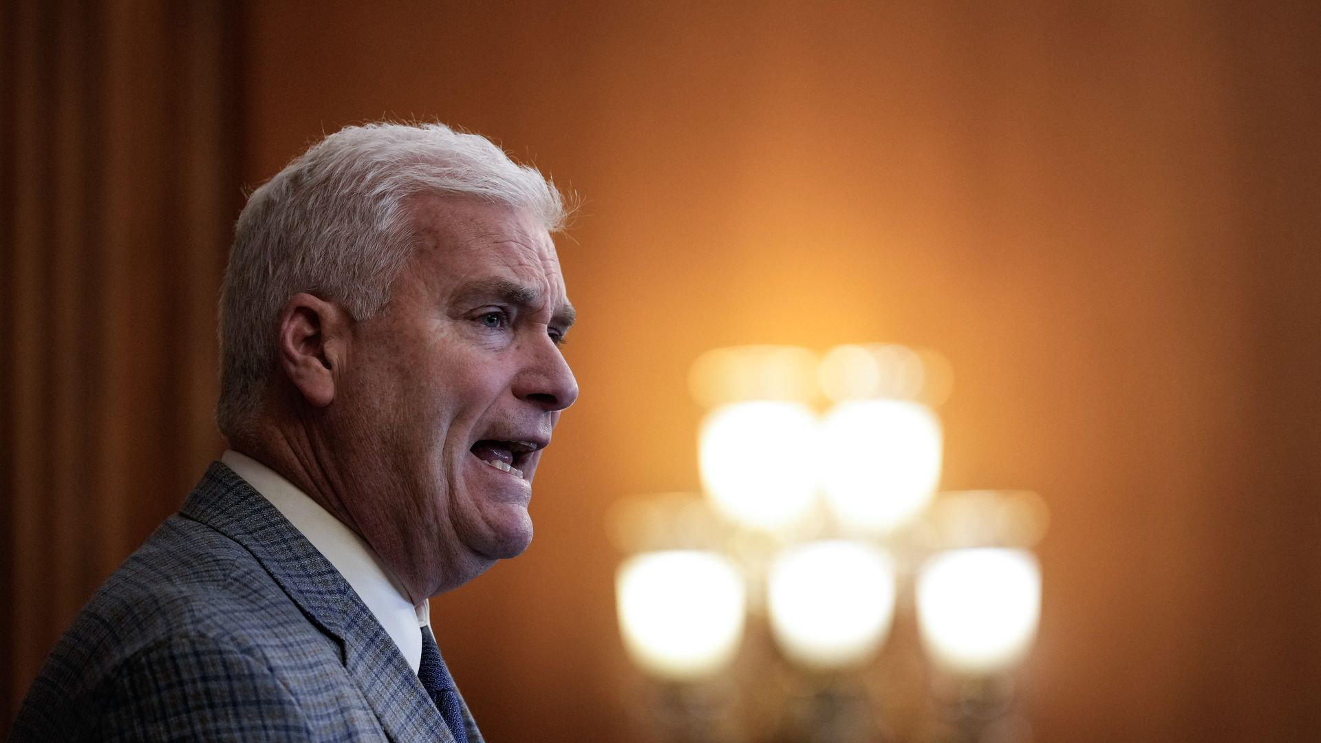 tom emmer from the side in a grey suit