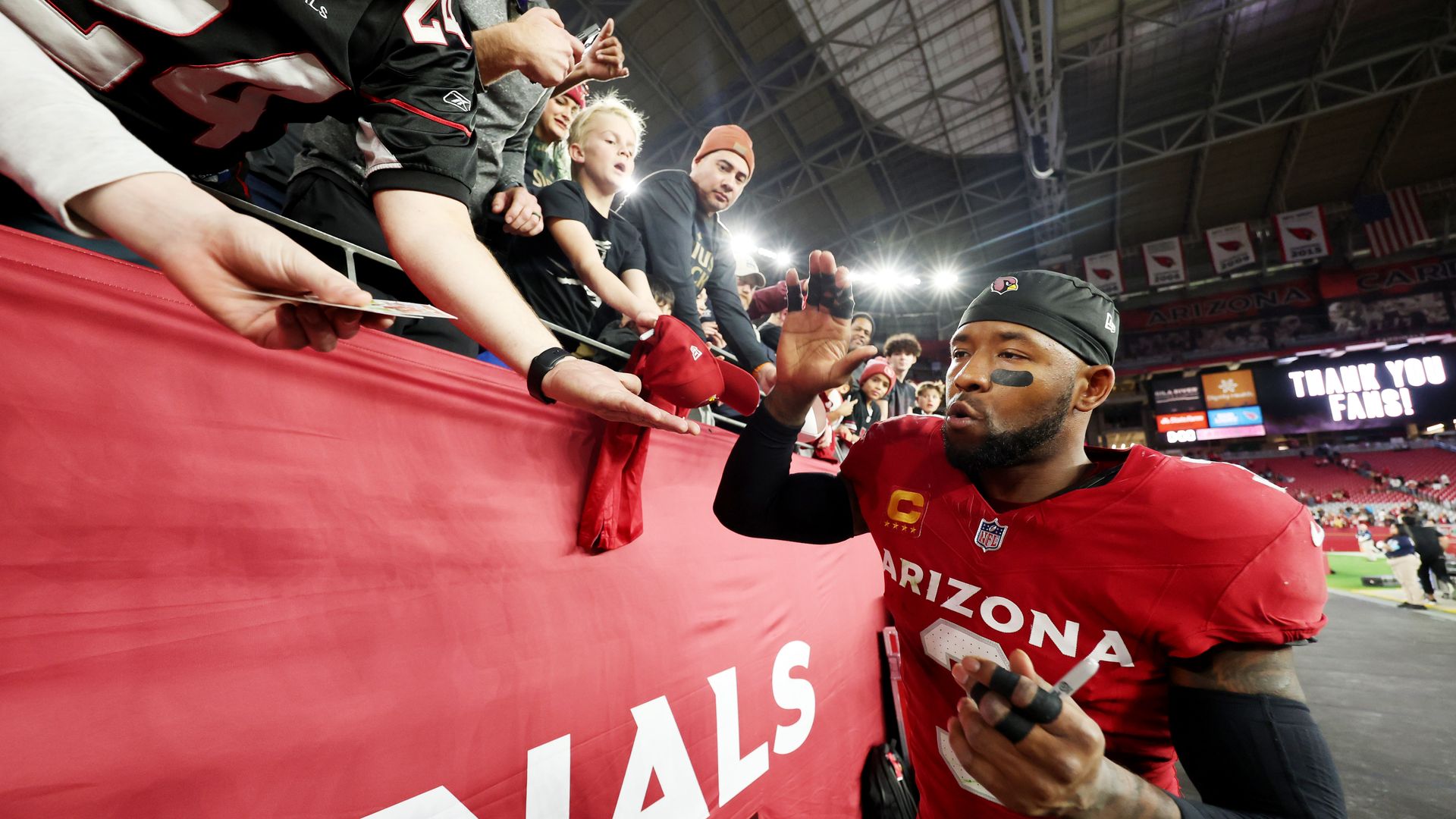 A football player greeting fans.
