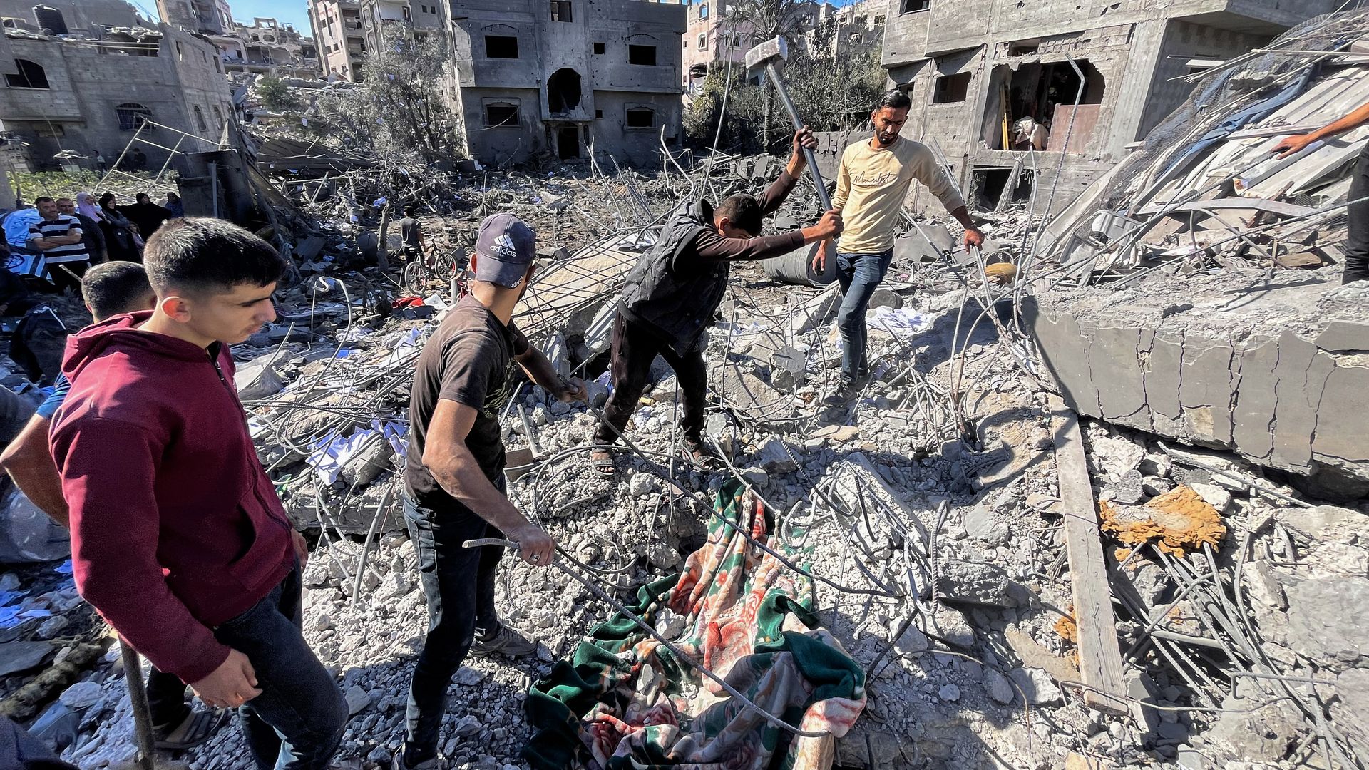 People search the rubble for missing persons at the site of an Israeli strike a day earlier that hit the Al-Loh family home in Beit Lahia, in the northern Gaza Strip on October 30, 2024, 