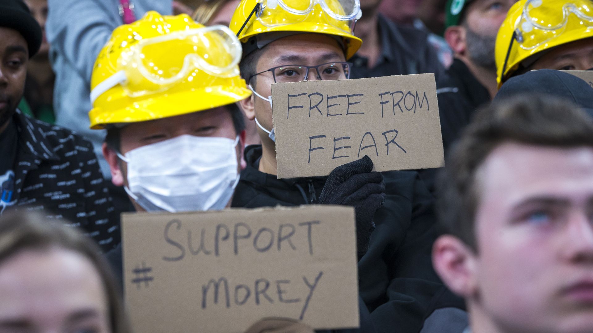 Protesters hold signs in support of Hong Kong during the third quarter. The Boston Celtics host the Cleveland Cavaliers in a pre-season NBA basketball game at TD Garden in Boston on Oct. 13, 2019.
