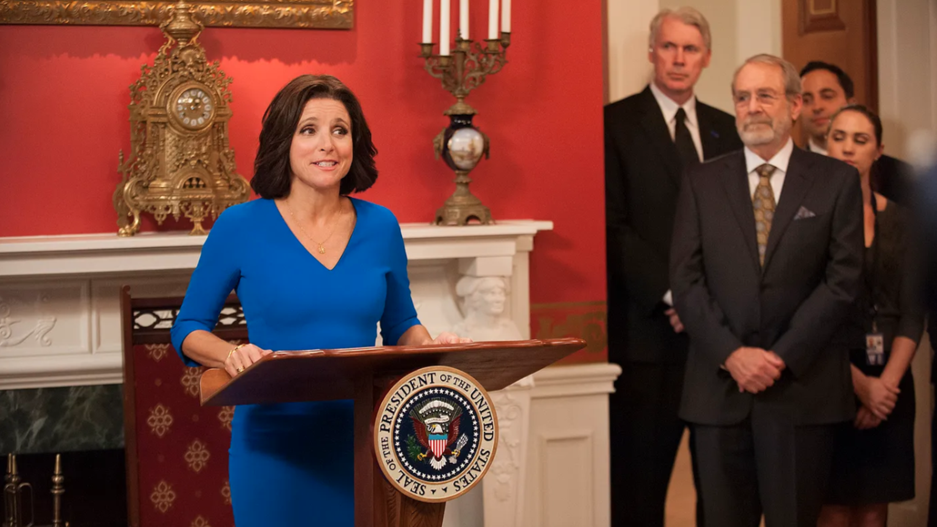 Julia Louis-Dreyfus stands in front of a podium as Selina Meyer in HBO's "Veep" 