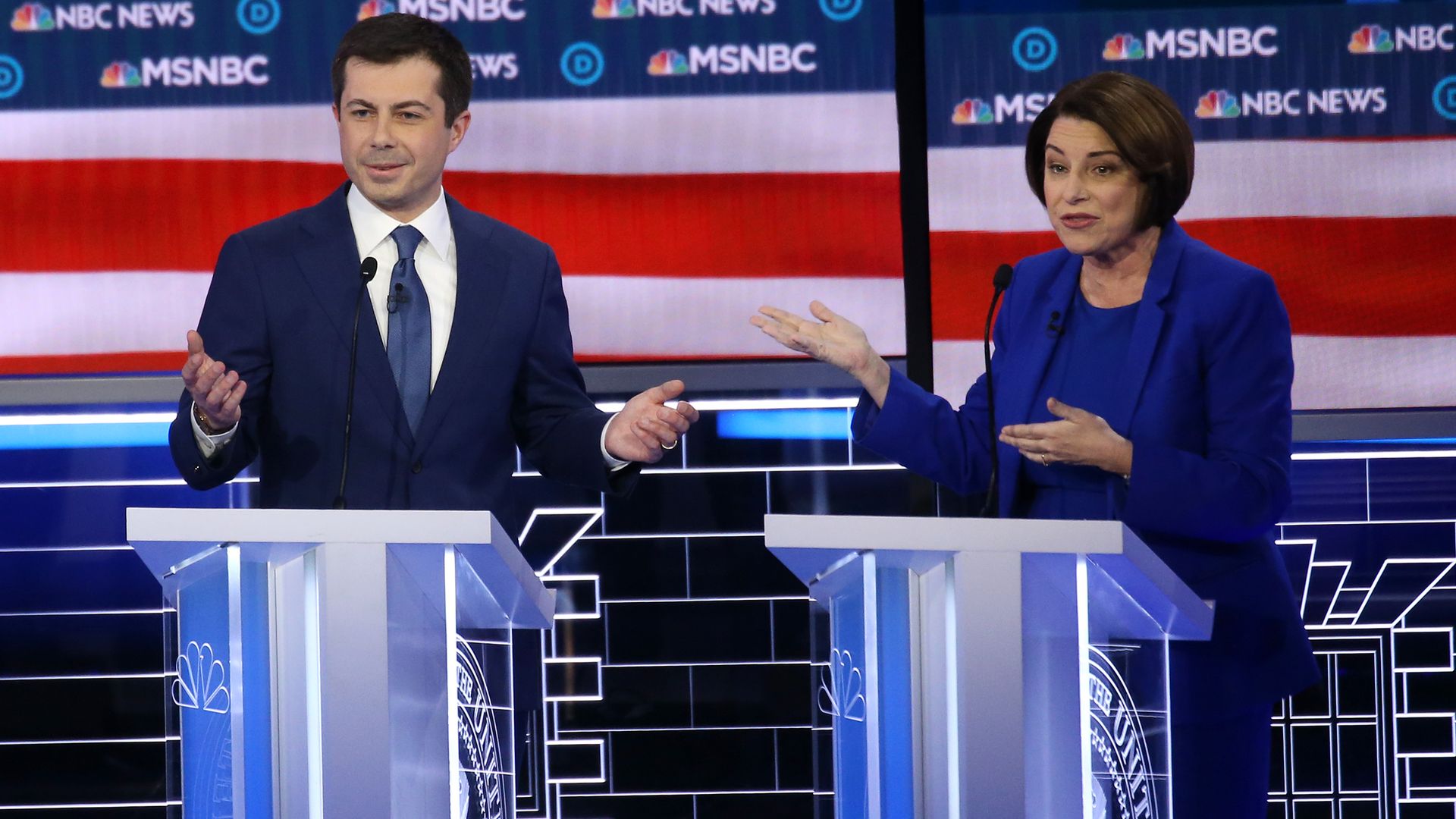 In this image, Buttigieg and Klobuchar stand next to each other on the debate stage.