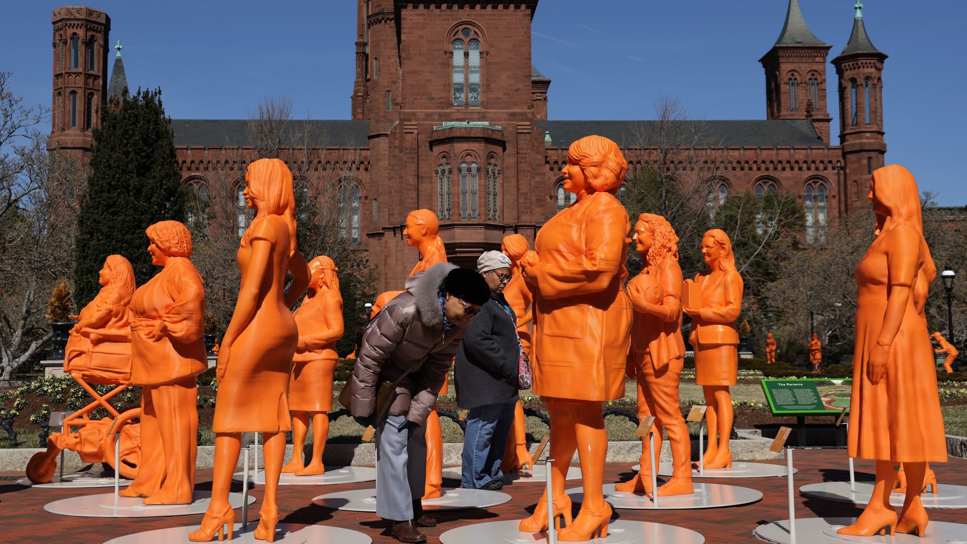Visitors admire life-size 3D-printed statues honoring women in STEM outside the Smithsonian Castle March 4, 2022 in Washington, DC. 