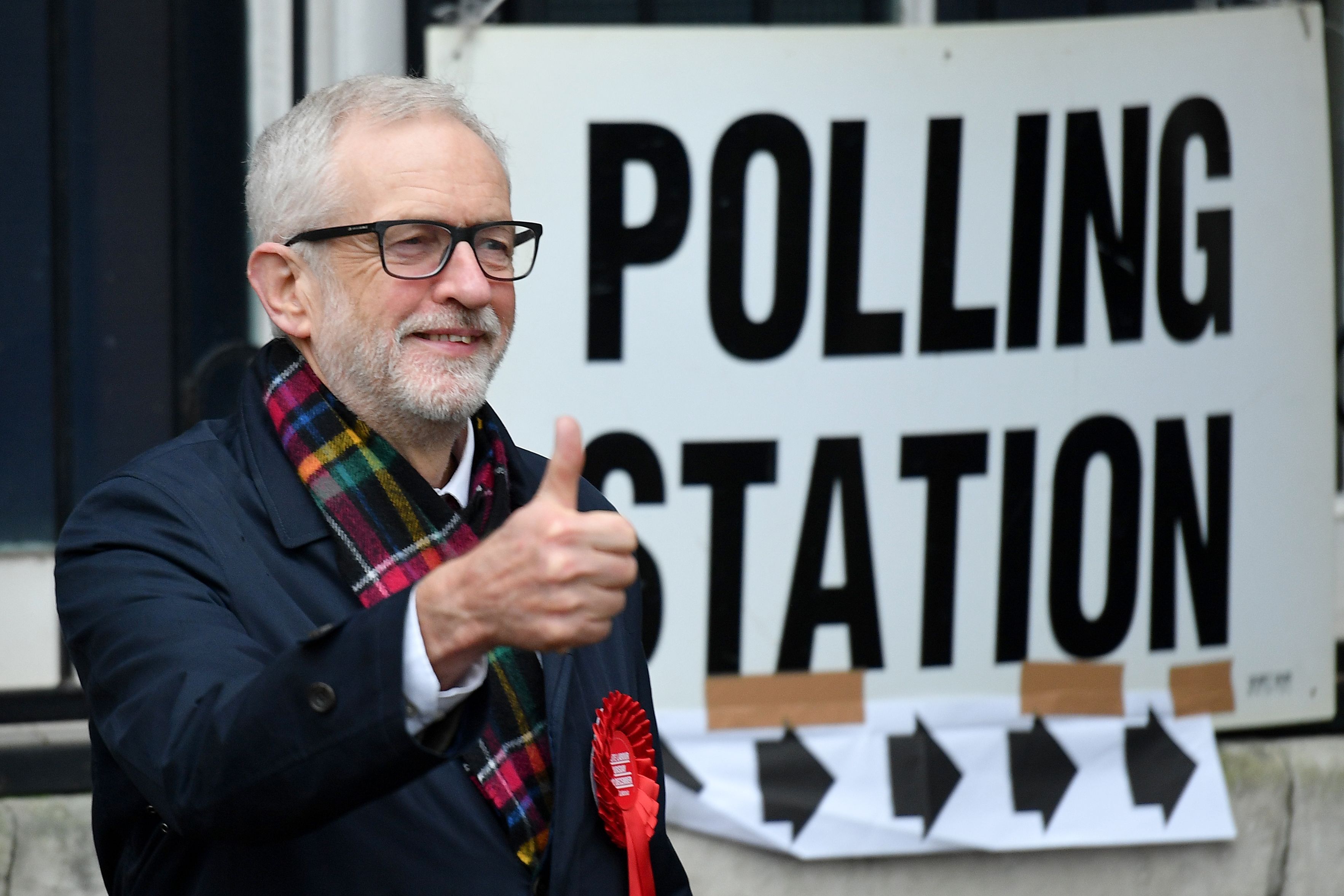 Britain's main opposition Labour Party leader Jeremy Corbyn poses as he arrive at a Polling Station to cast his ballot paper and vote, in north London