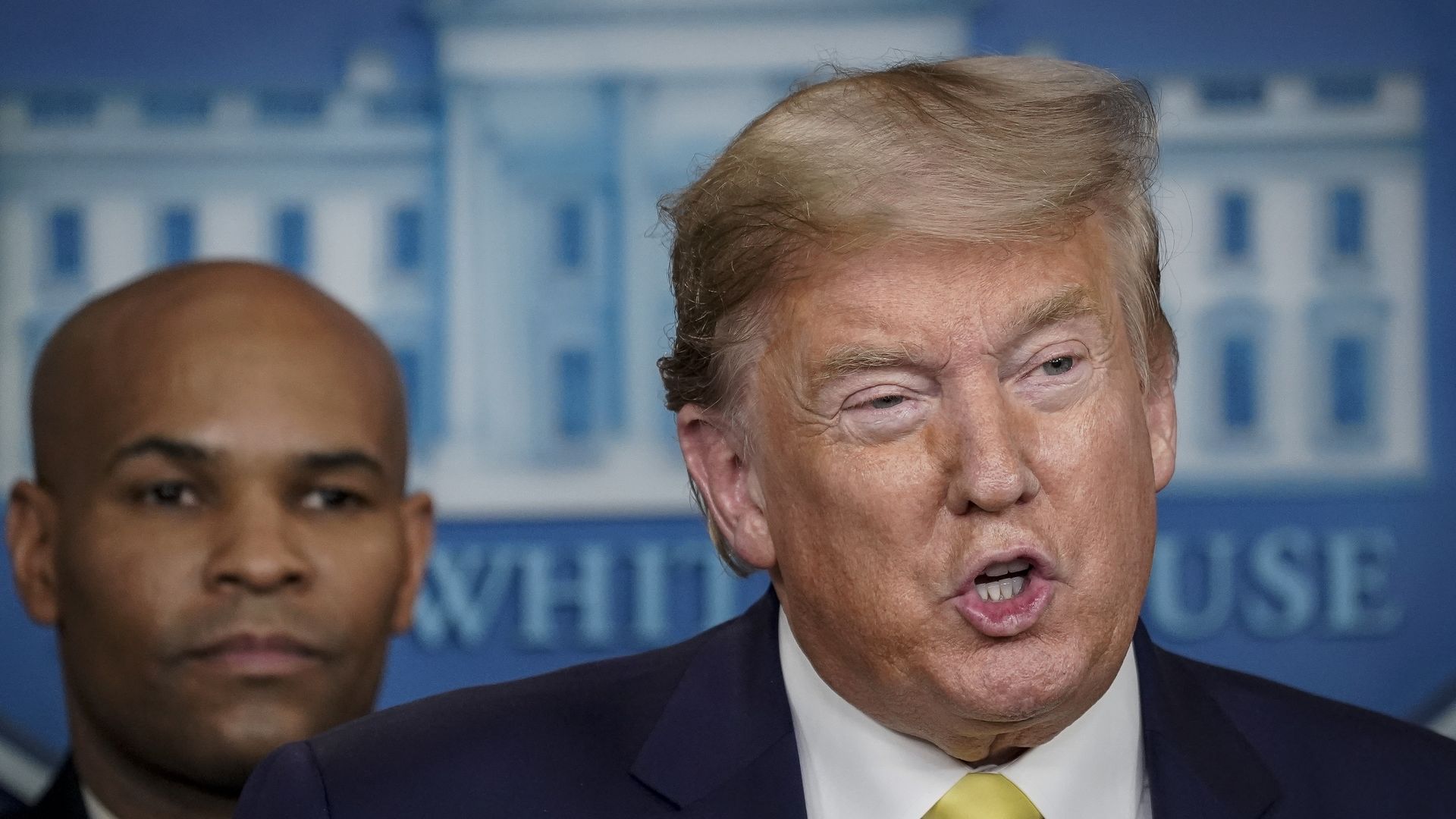 U.S. Surgeon General Dr. Jerome Adams looks on as U.S. President Donald Trump speaks during a press briefing with members of the White House Coronavirus Task Force team