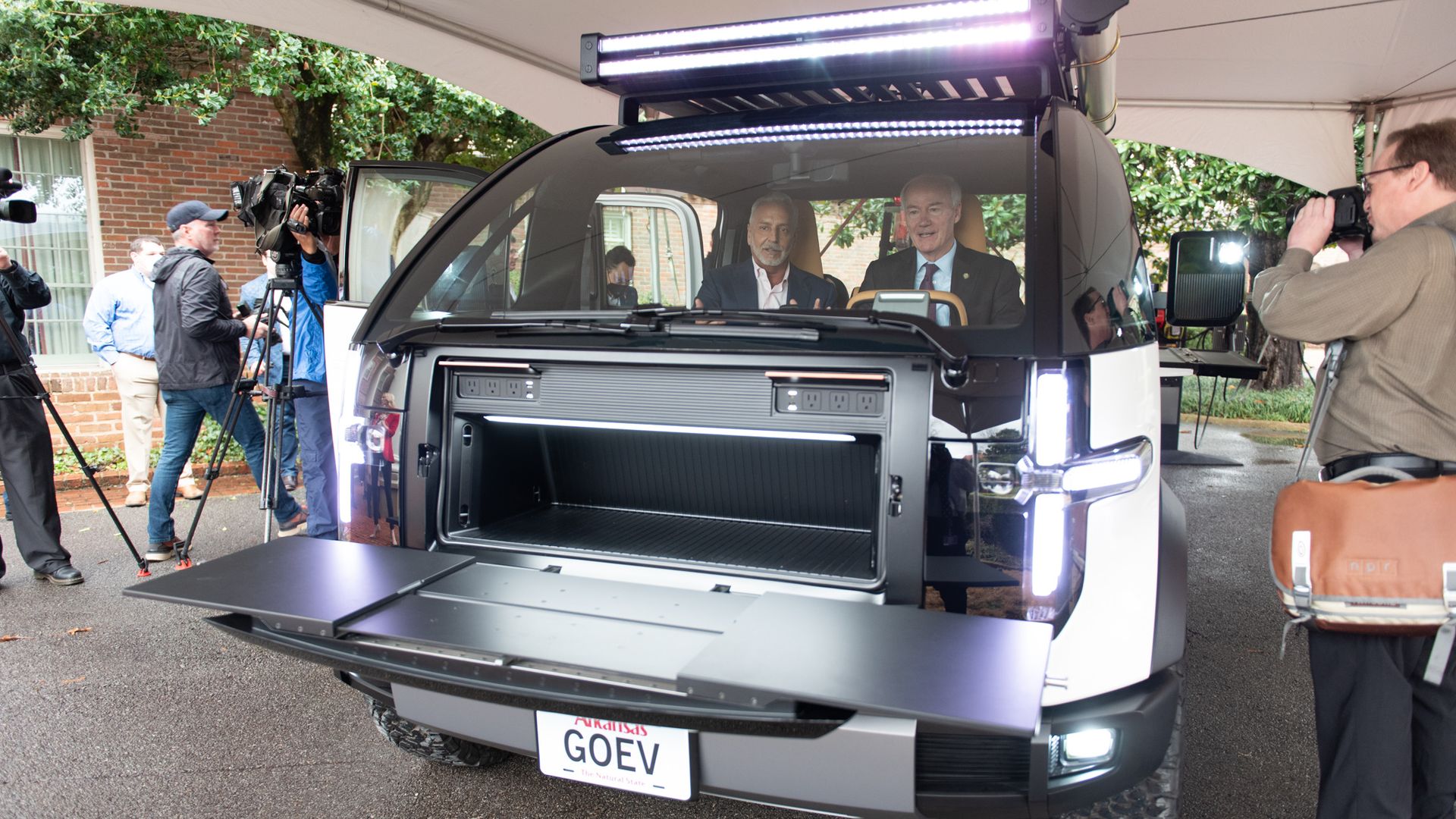 Canoo CEO, Tony Aquila shows Gov. Asa Hutchinson a prototype at an event announcing the Arkansas Council Future Mobility.