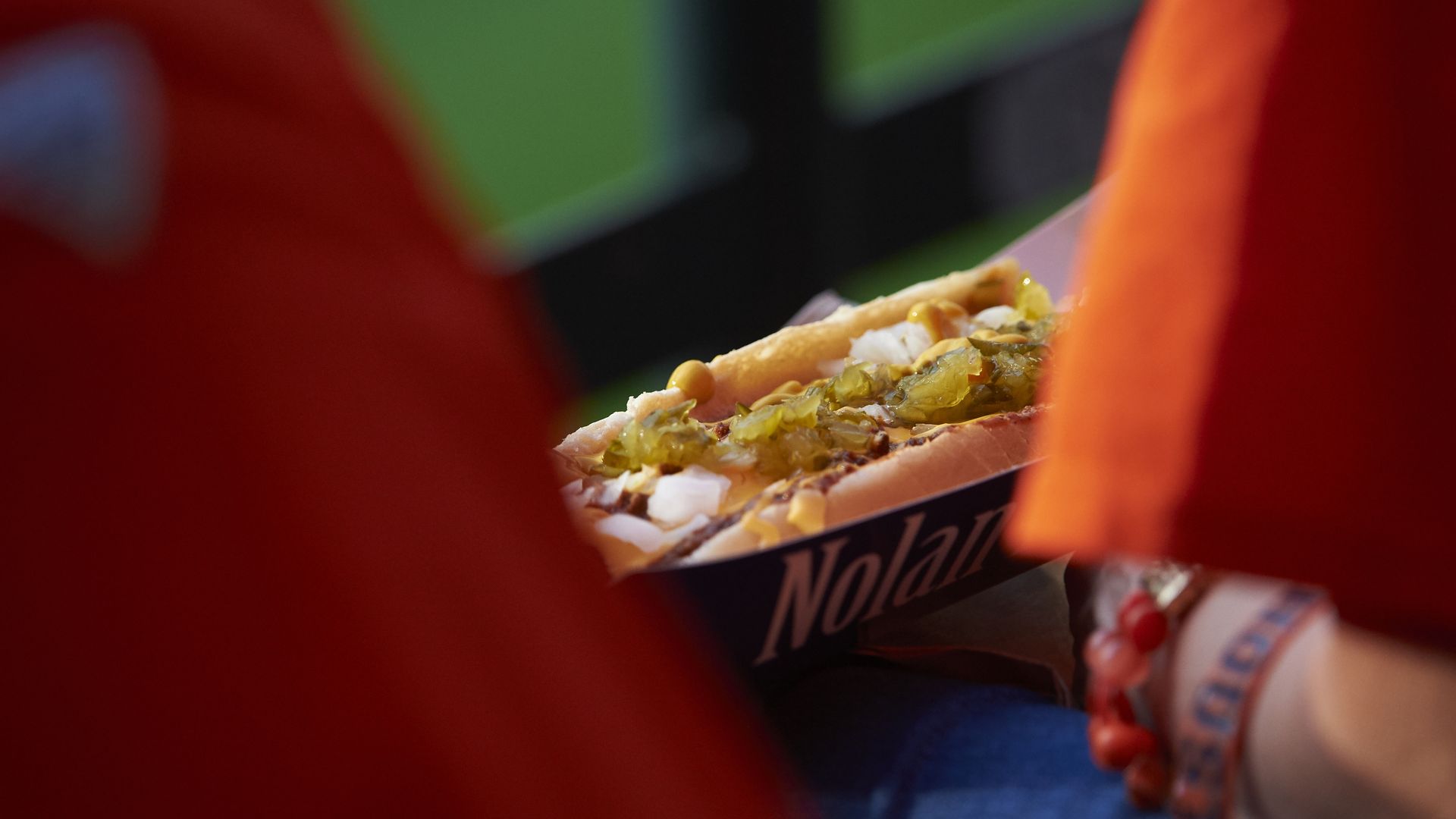 A fan eats a hotdog before the first pitch between the Houston Astros and the Baltimore Orioles at Minute Maid Park