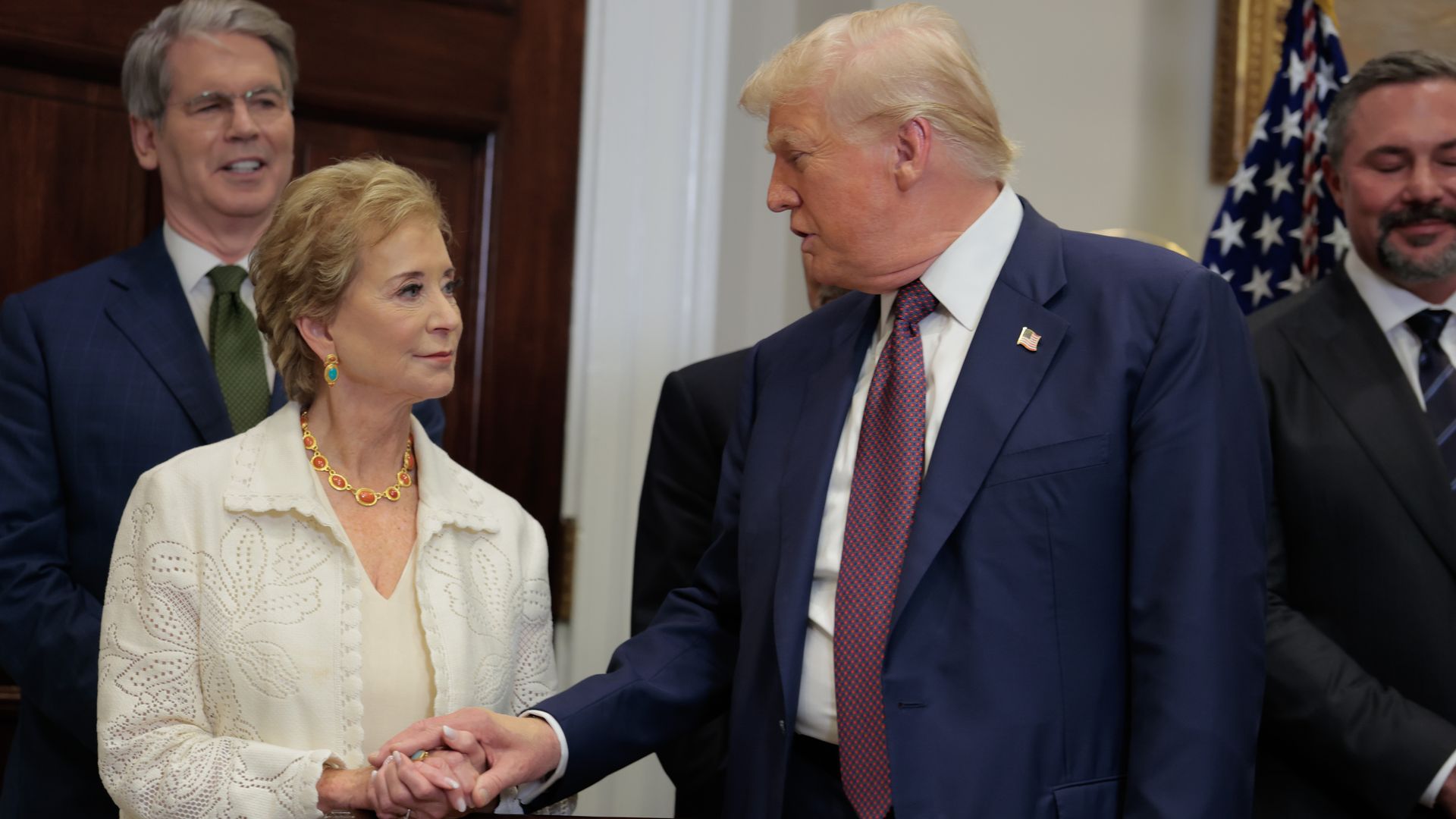 Donald Trump shakes hands with Linda McMahon in the Oval Office