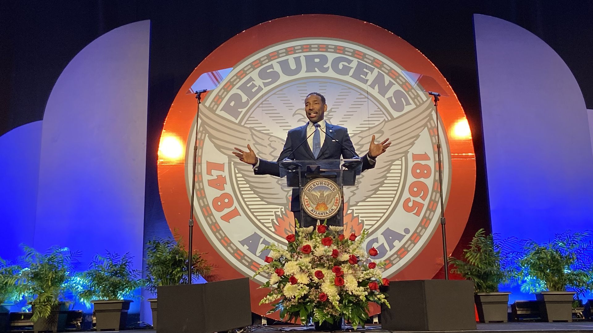 Mayor Andre Dickens stands at a lectern in front of the Atlanta city seal