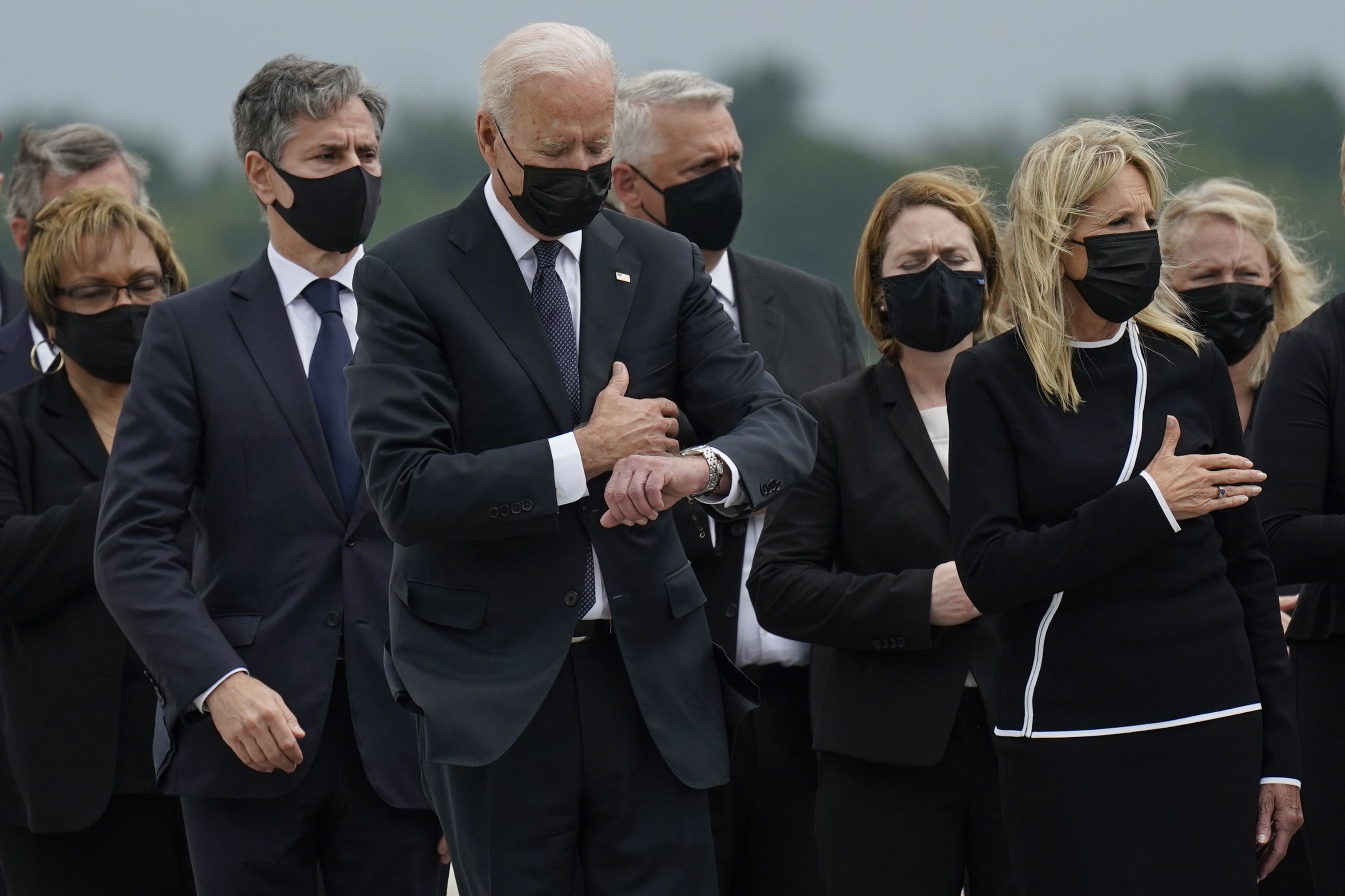 President Biden looks at his watch in a photo taken at 11:51am on Aug. 29, 2021, during a ceremony for soldiers killed in an attack during the Afghanistan withdrawal.