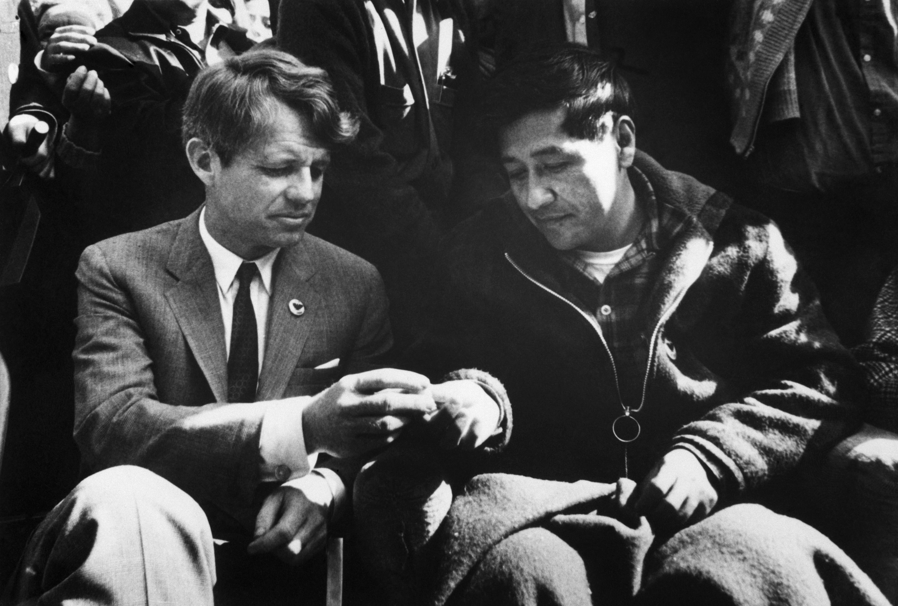 Sen. Robert Kennedy (D-N.Y.) breaks bread with farmworker union leader Cesar Chavez as Chavez ended a 25-day fast in support of non-violence in the strike against grape growers, Delano, California, March, 10, 1968.