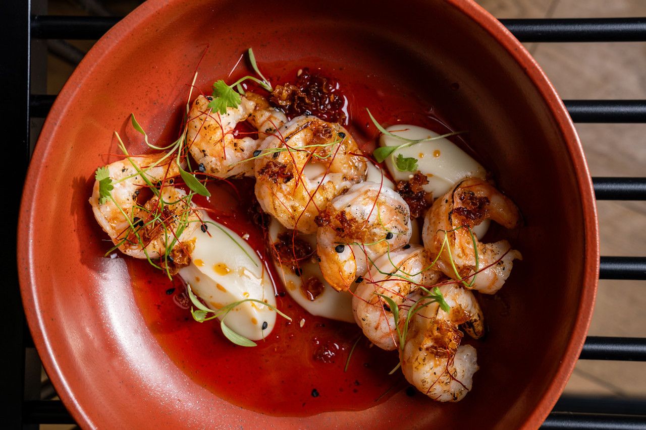 Gambas al ajillo in a red bowl