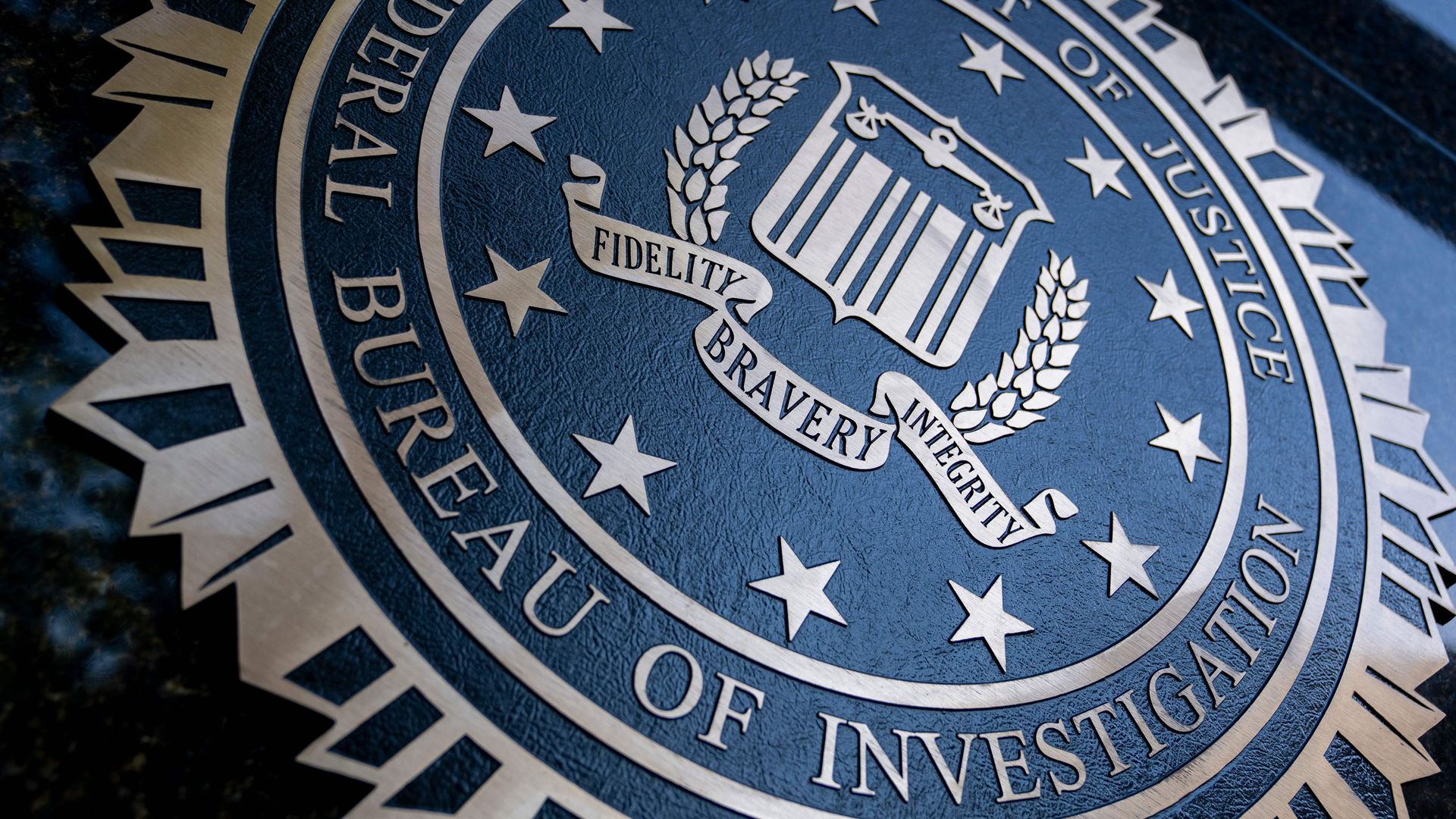 Photo of a large FBI seal hanging from a wall