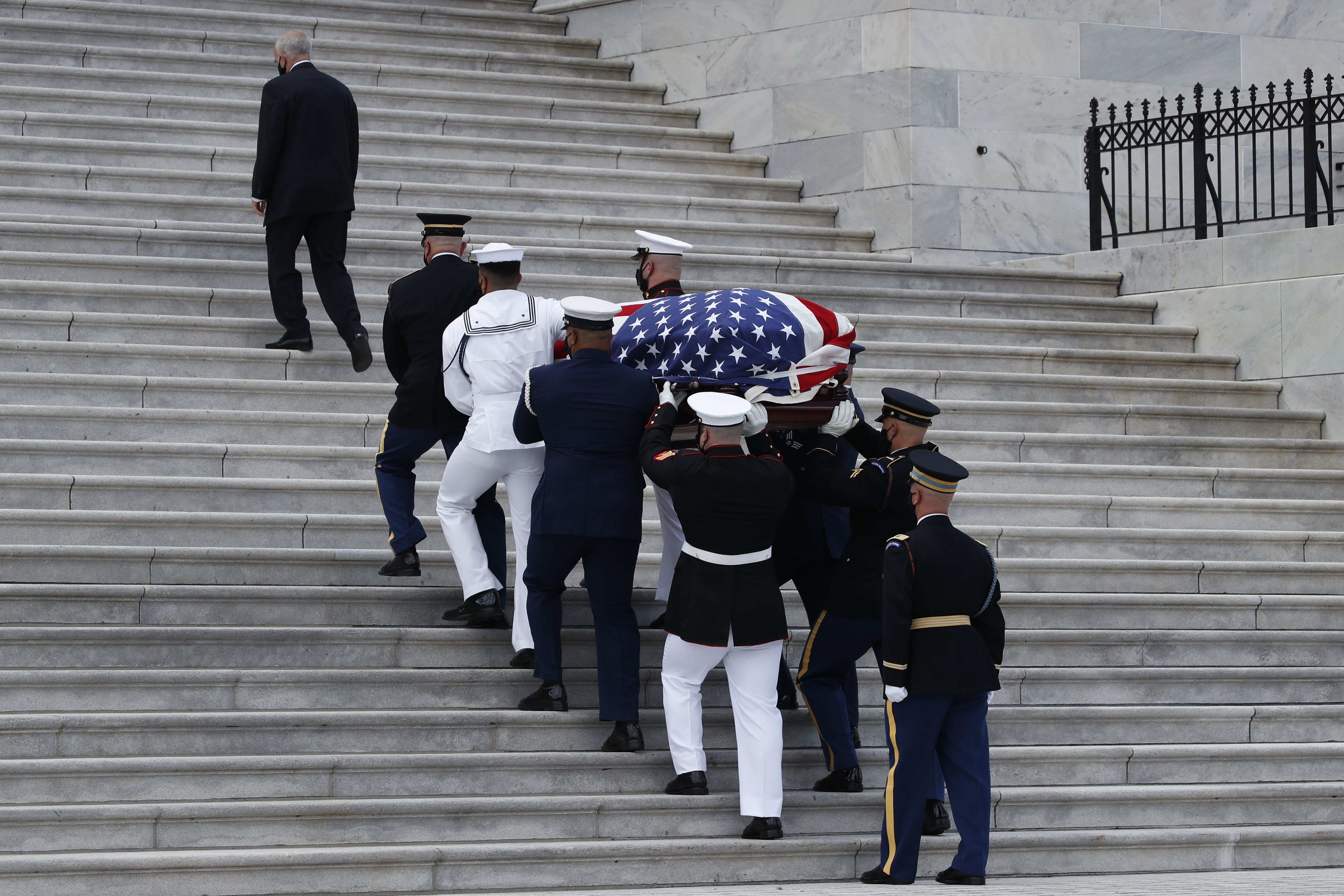 The flag-draped casket of Rep. John Lewis, D-Ga., is carried by a joint services military honor guard to lie in state